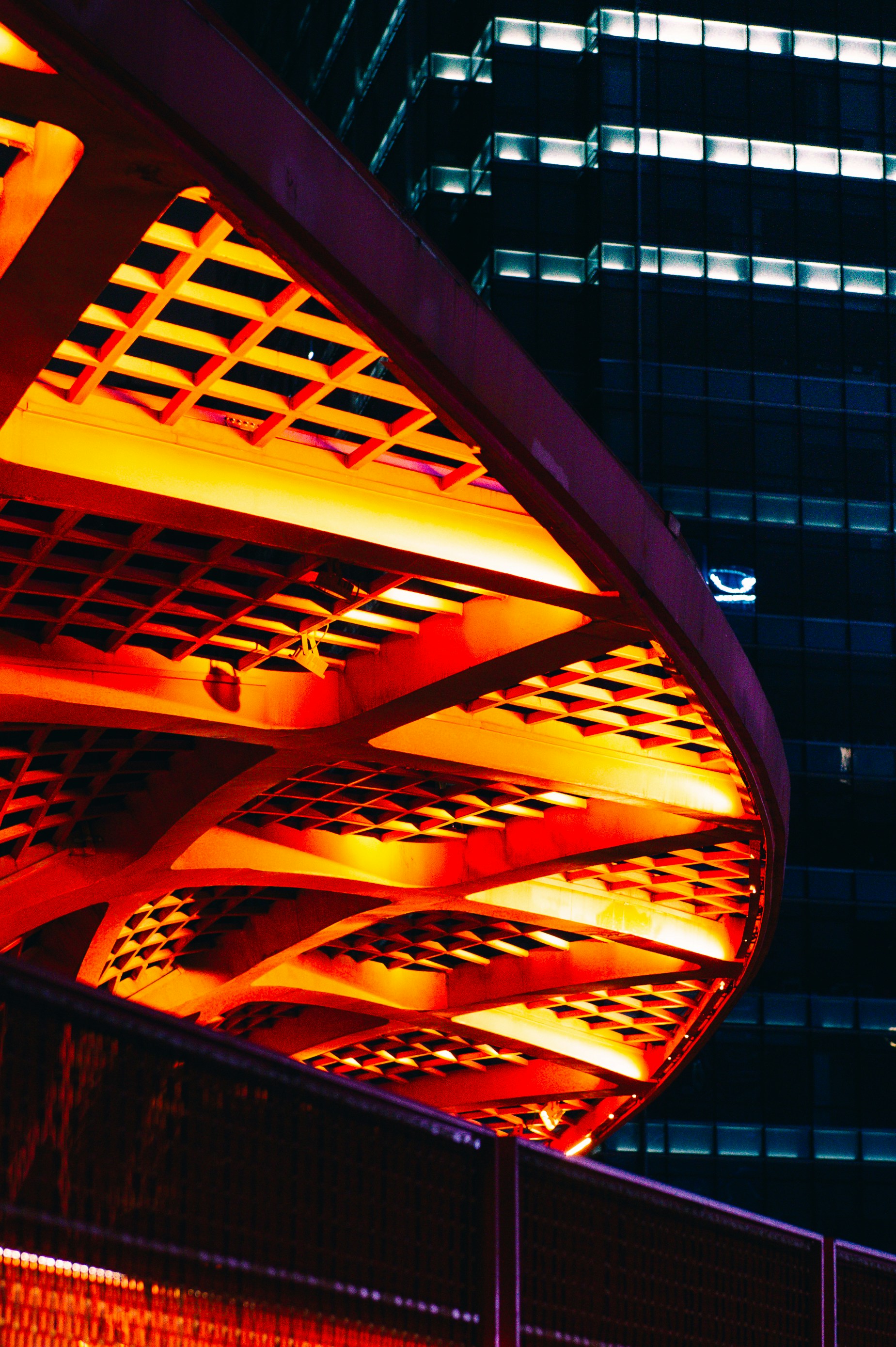 A tall building with a lit up clock on it's side