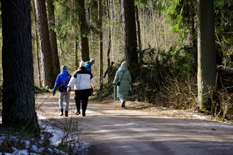 A group of people walking down a snow covered road