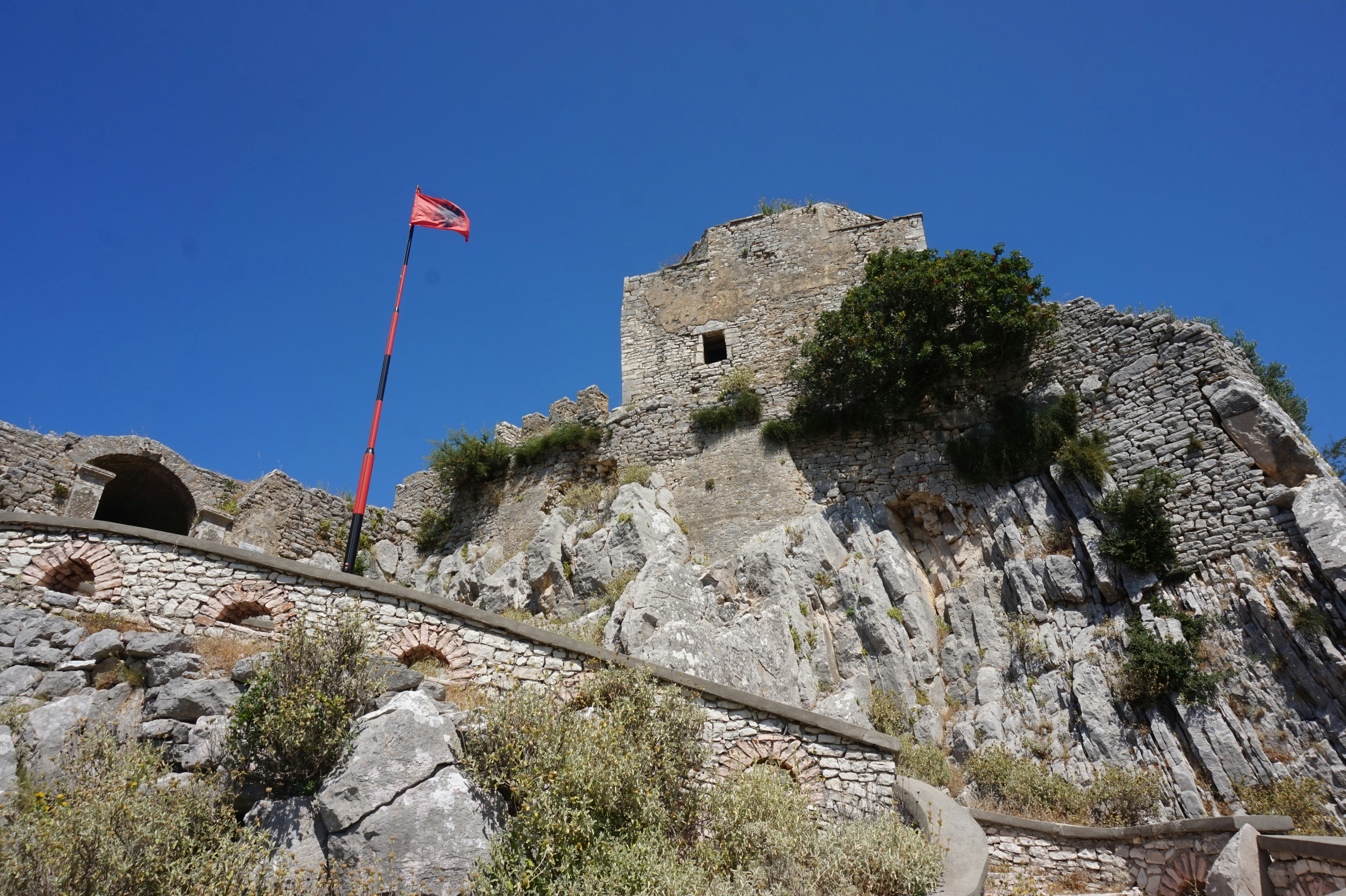 A stone castle with a flag on top of it