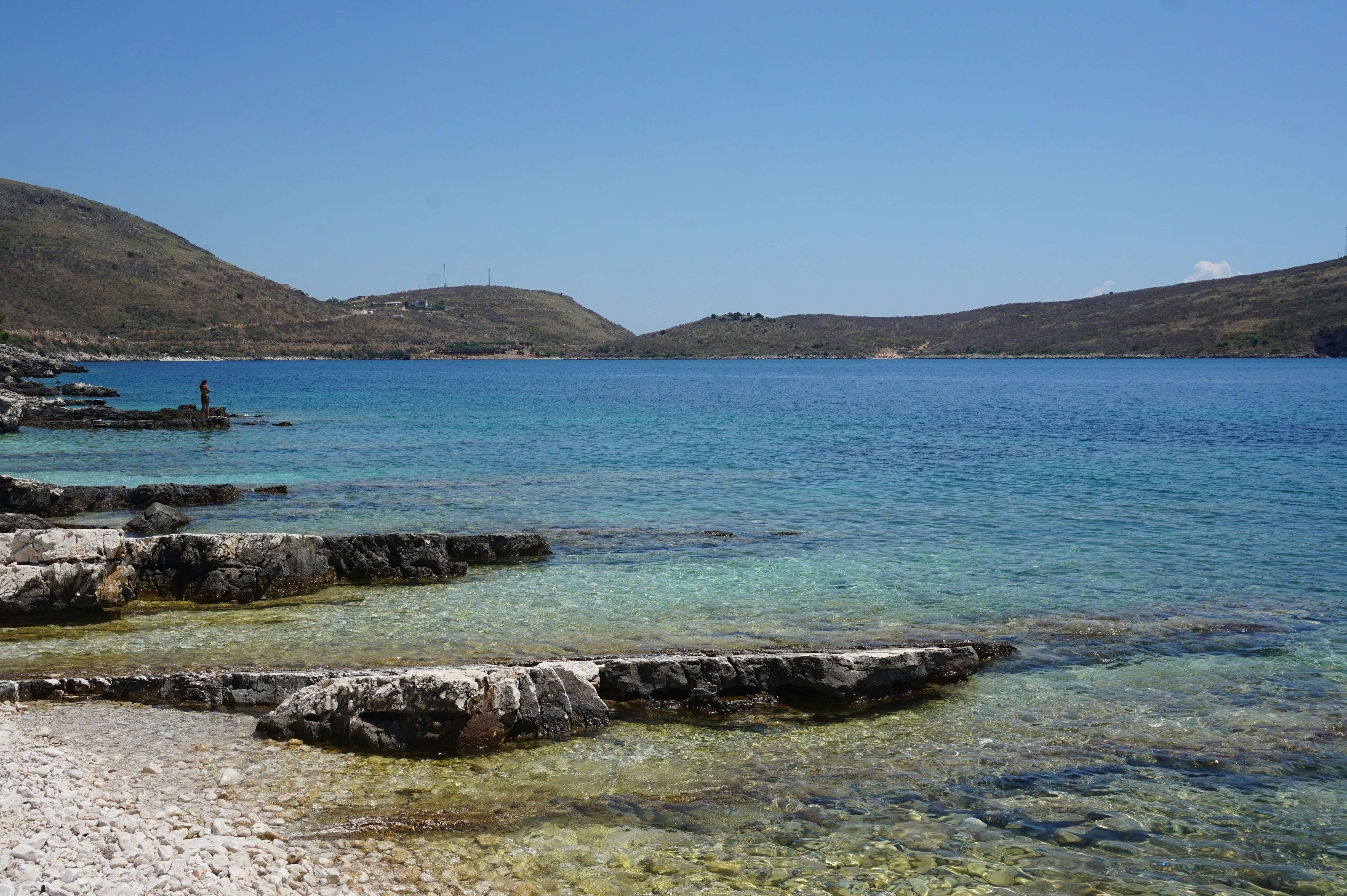 Stones in the turquoise ocean at Porto Palermo Beach in Albania. When using my images please cite me as follows: Marie Volkert / Reiseblog Worldonabudget and link to my website: www.worldonabudget.de