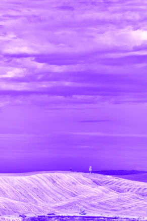 A snow covered hill with a tower in the distance