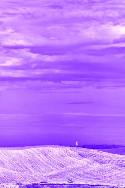 A snow covered hill with a tower in the distance