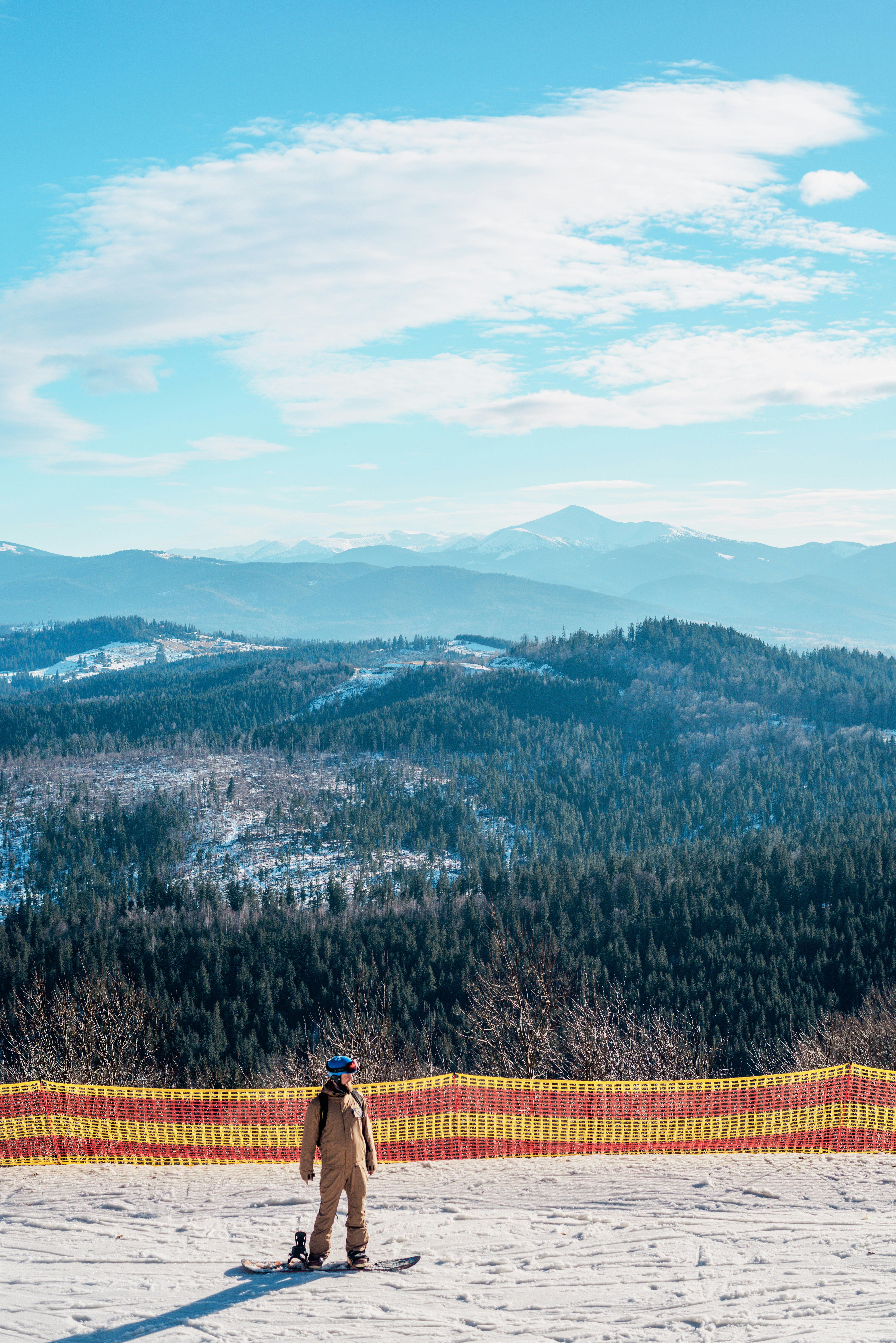 A man standing on top of a snow covered slope
