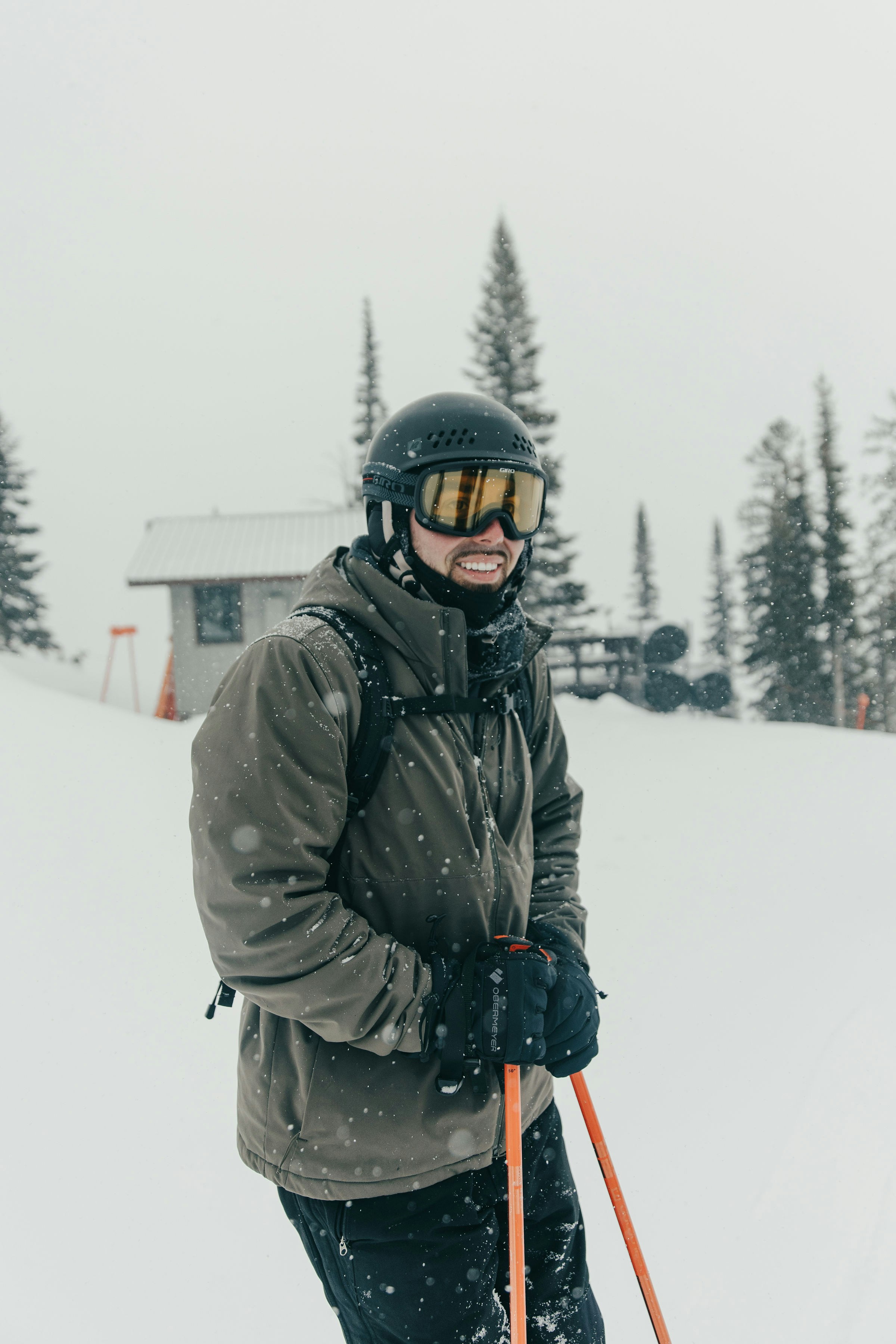 A man riding skis down a snow covered slope