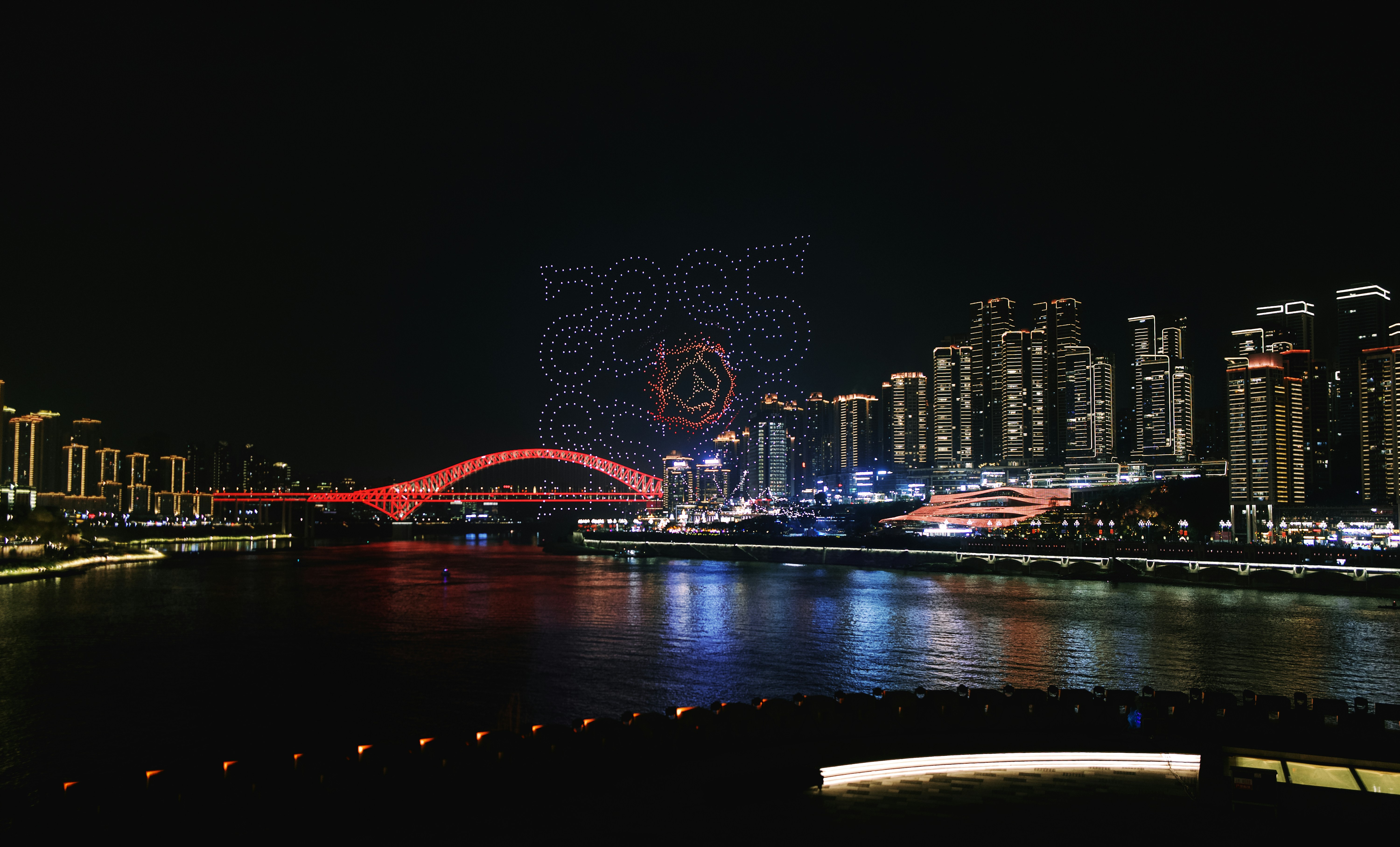 A view of a city at night from across the river