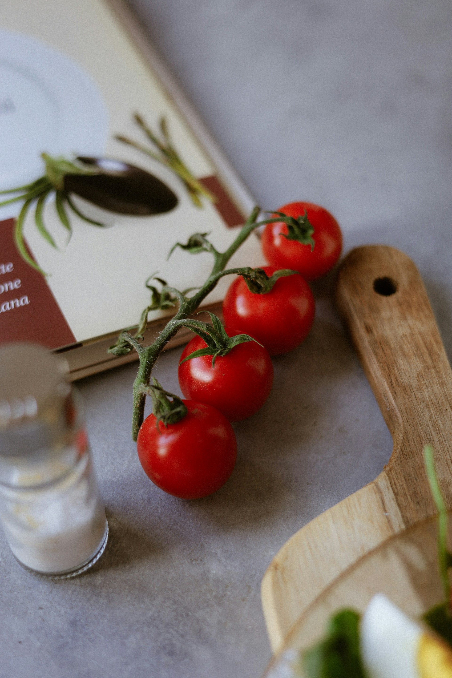 A book and some tomatoes on a table