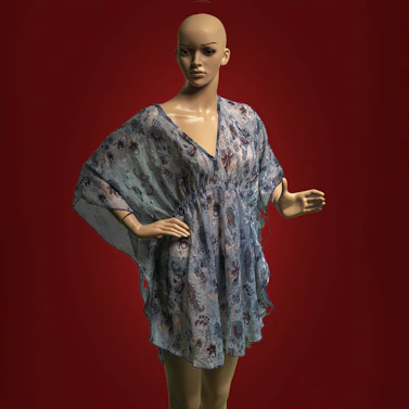 A female mannequin wearing a blue dress and green tights