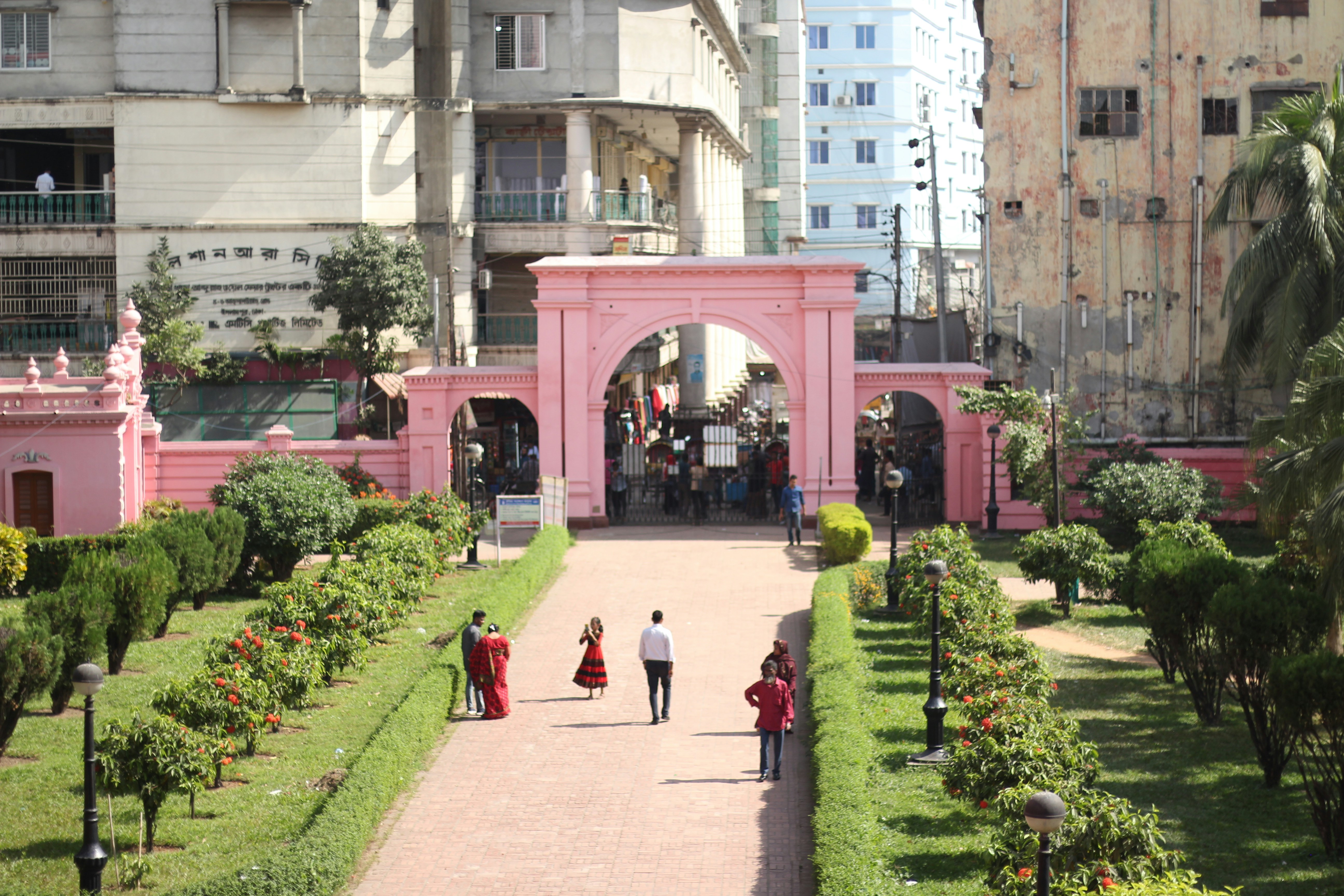 A couple of people that are walking down a path