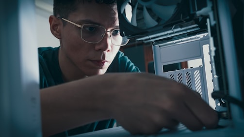 A technician performing maintenance on a computer