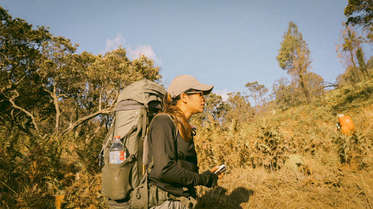 A woman with a backpack and a cell phone