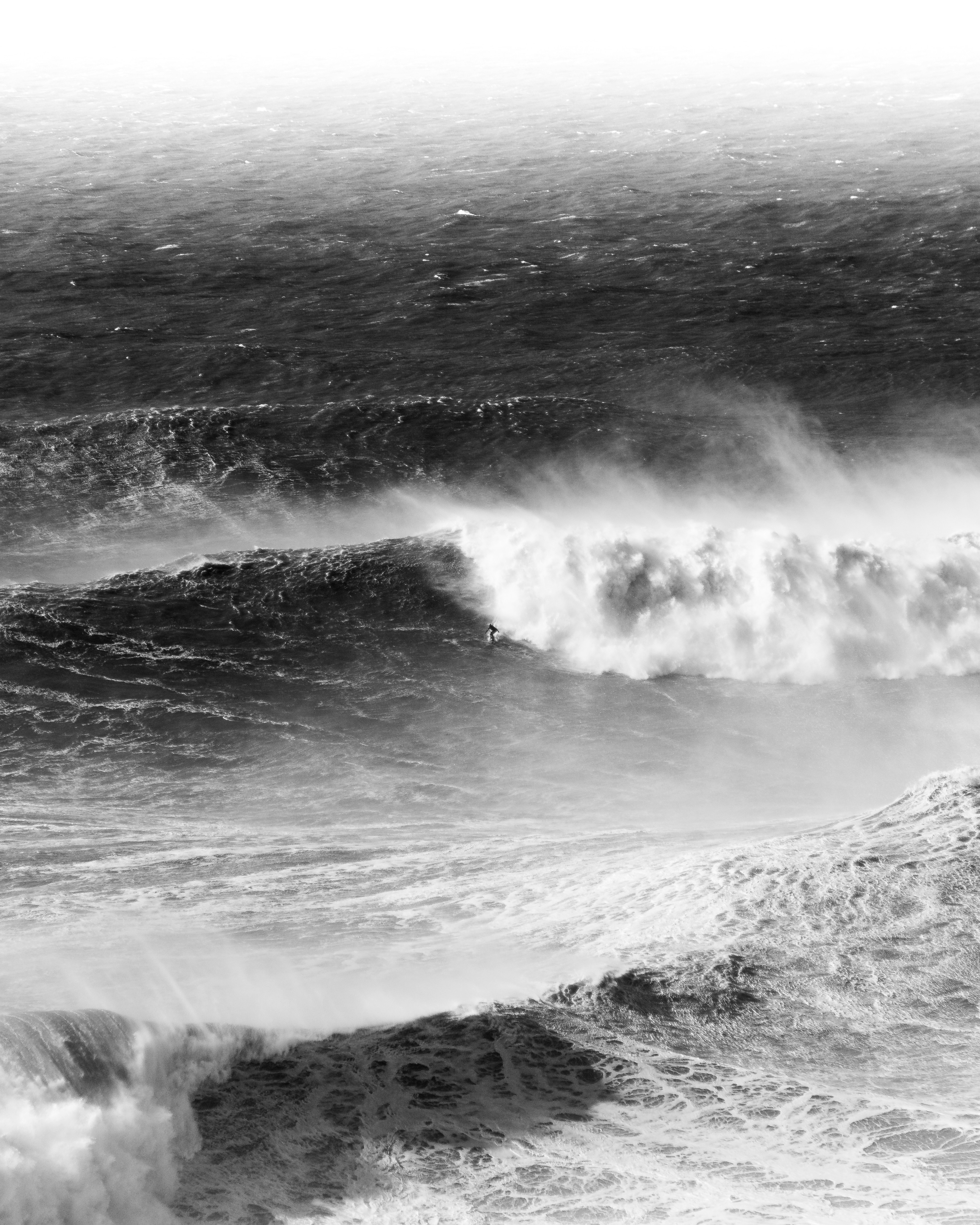 A man riding a wave on top of a surfboard