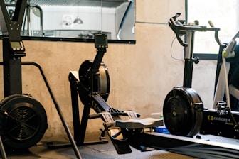 A gym room with a stationary bike and exercise equipment