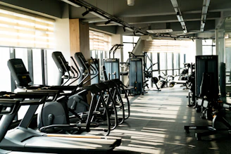A row of exercise machines in a gym