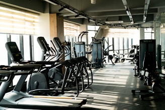 A row of exercise machines in a gym