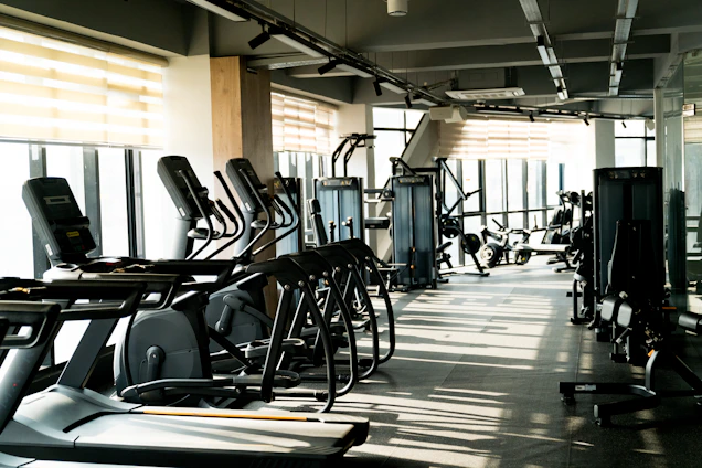 A row of exercise machines in a gym