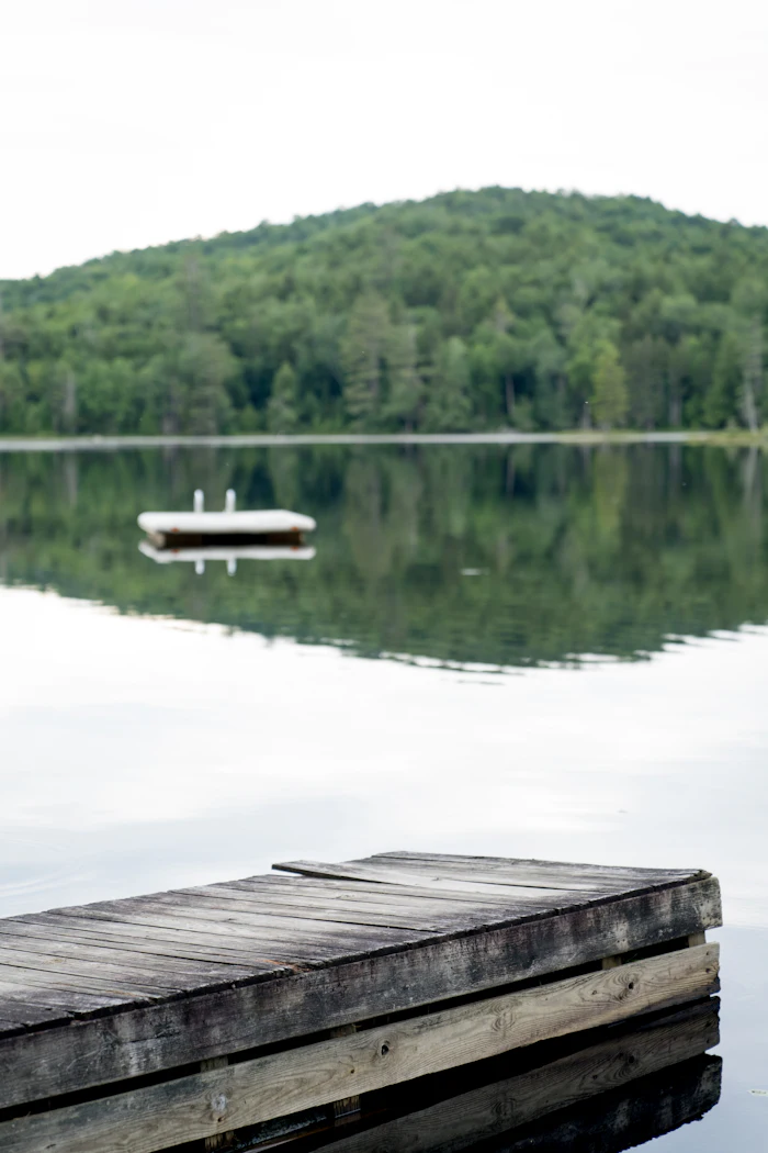 Wooden dock on a calm New England lake