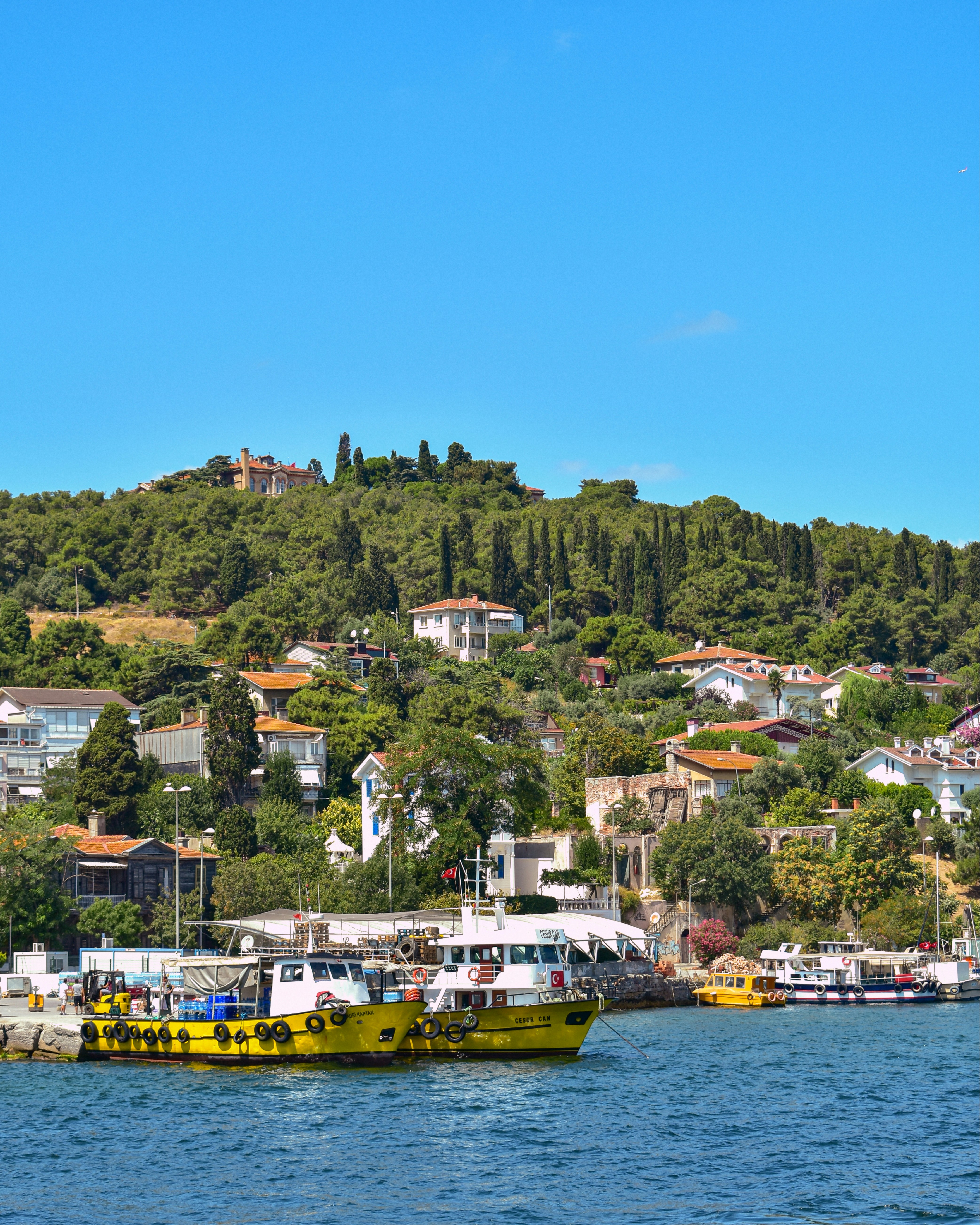 A yellow boat floating on top of a body of water