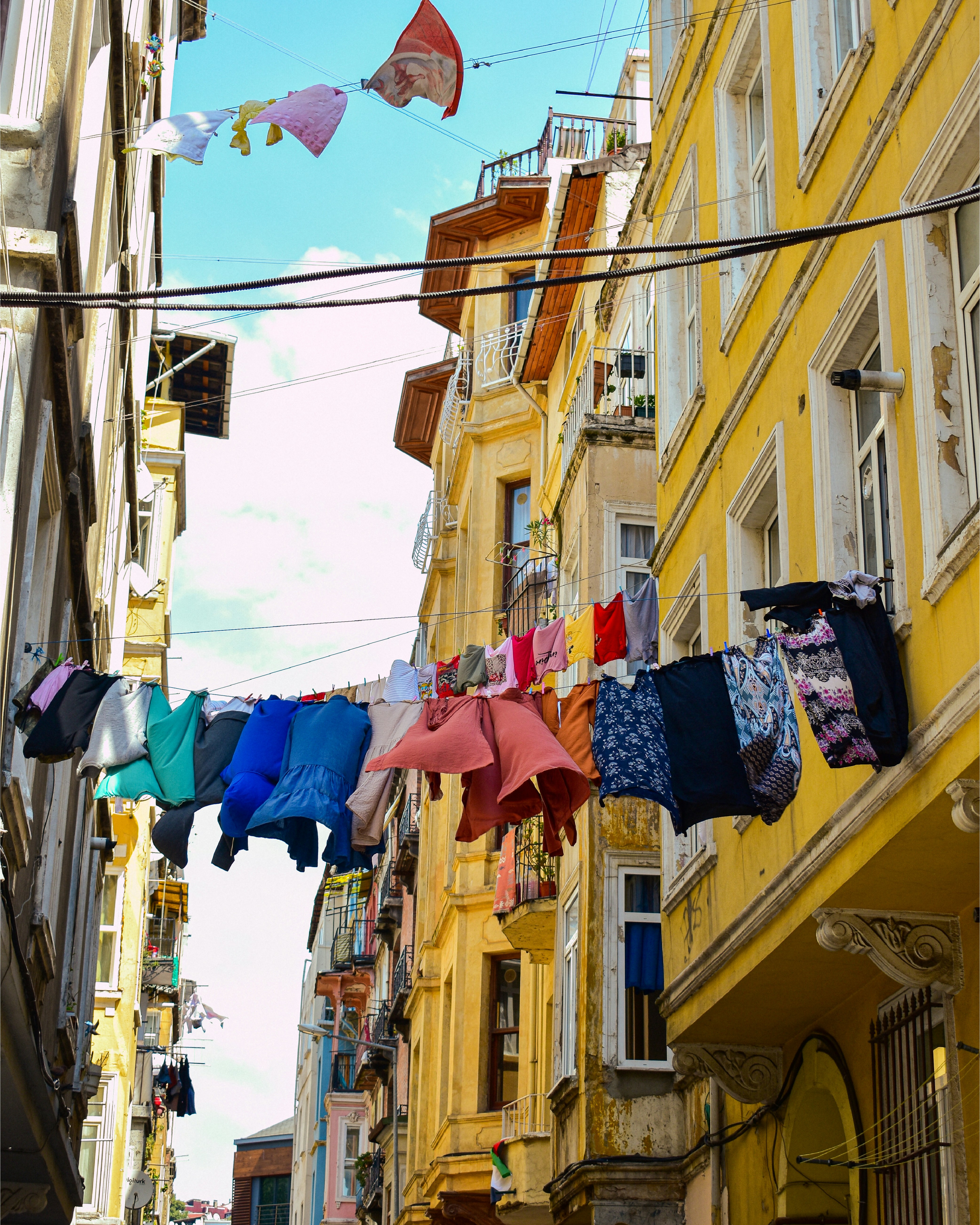 A bunch of clothes hanging from a line in a city