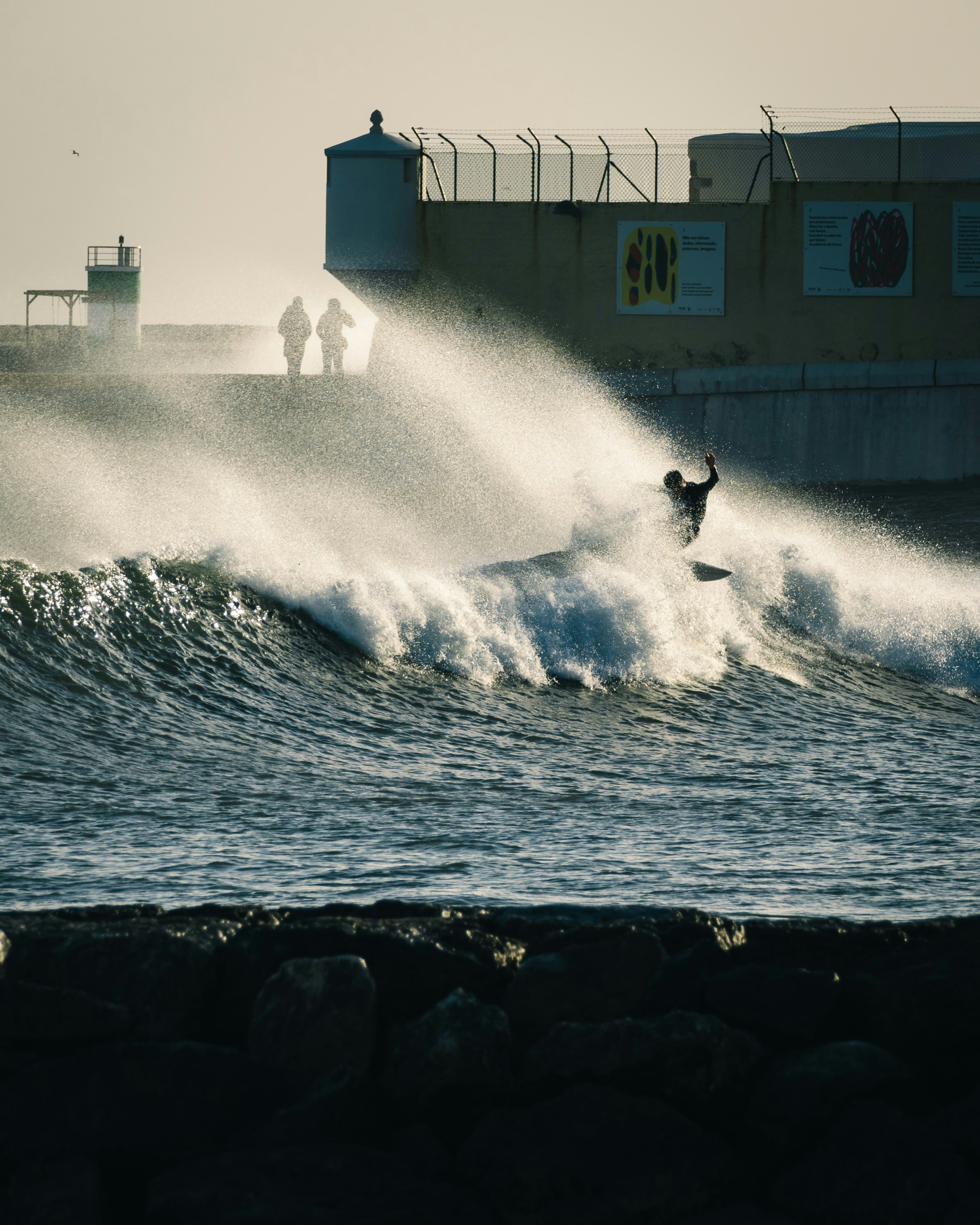 A person riding a wave on top of a surfboard