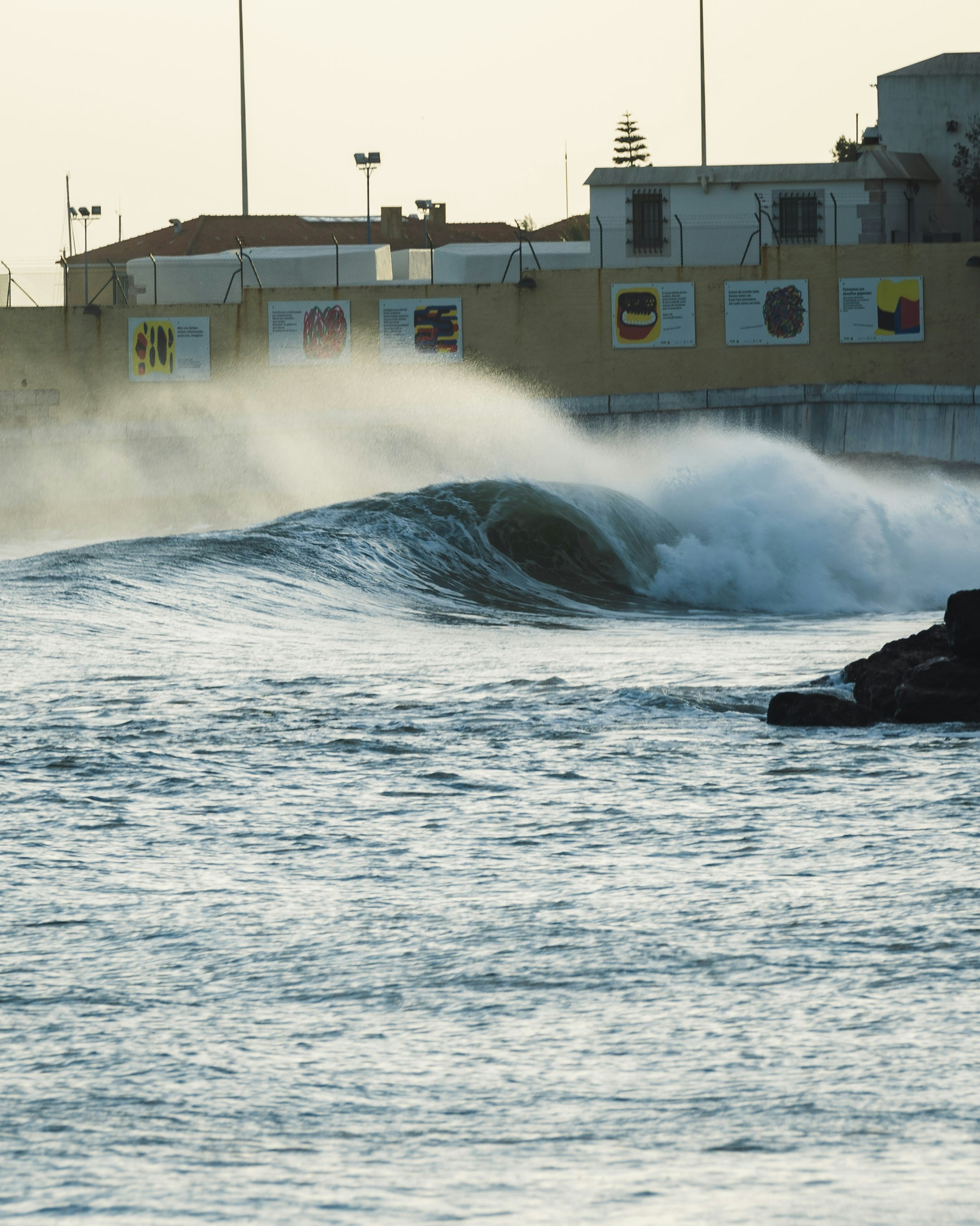 A person riding a surfboard on a wave in the ocean