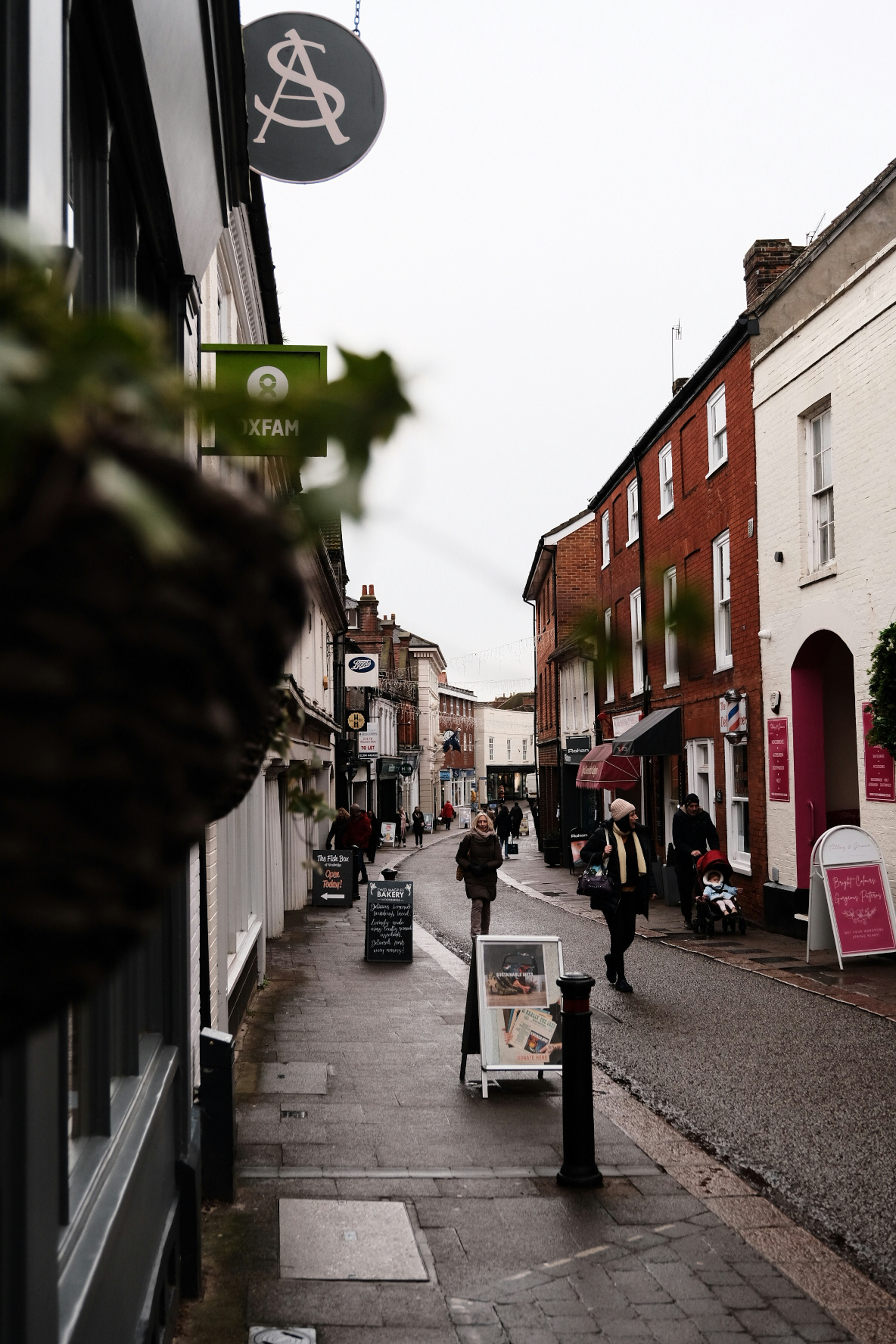 A city street with people walking down it