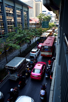 A street filled with lots of traffic next to tall buildings