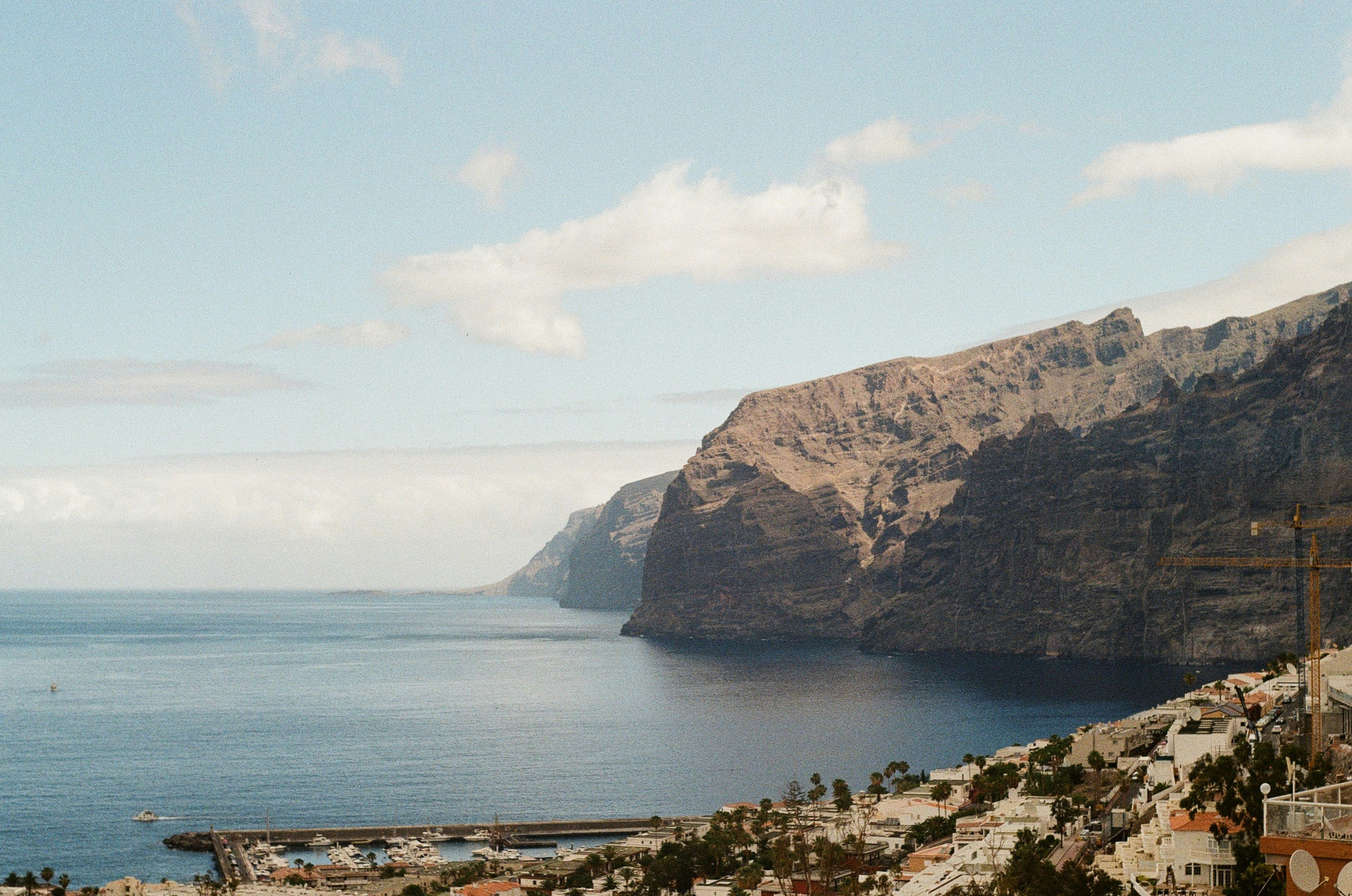 A view of the ocean and mountains from a hill