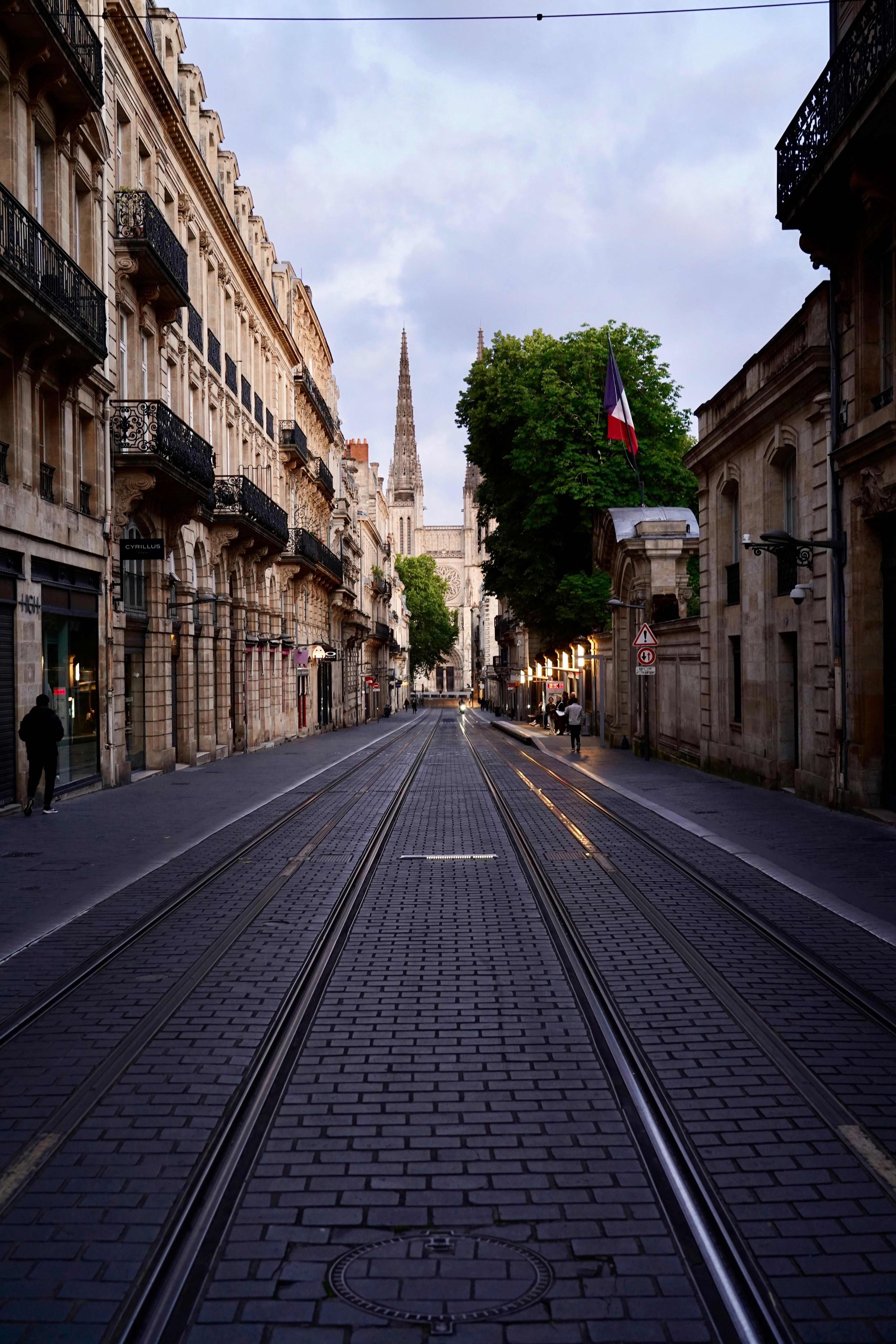 A city street with a train track going through it