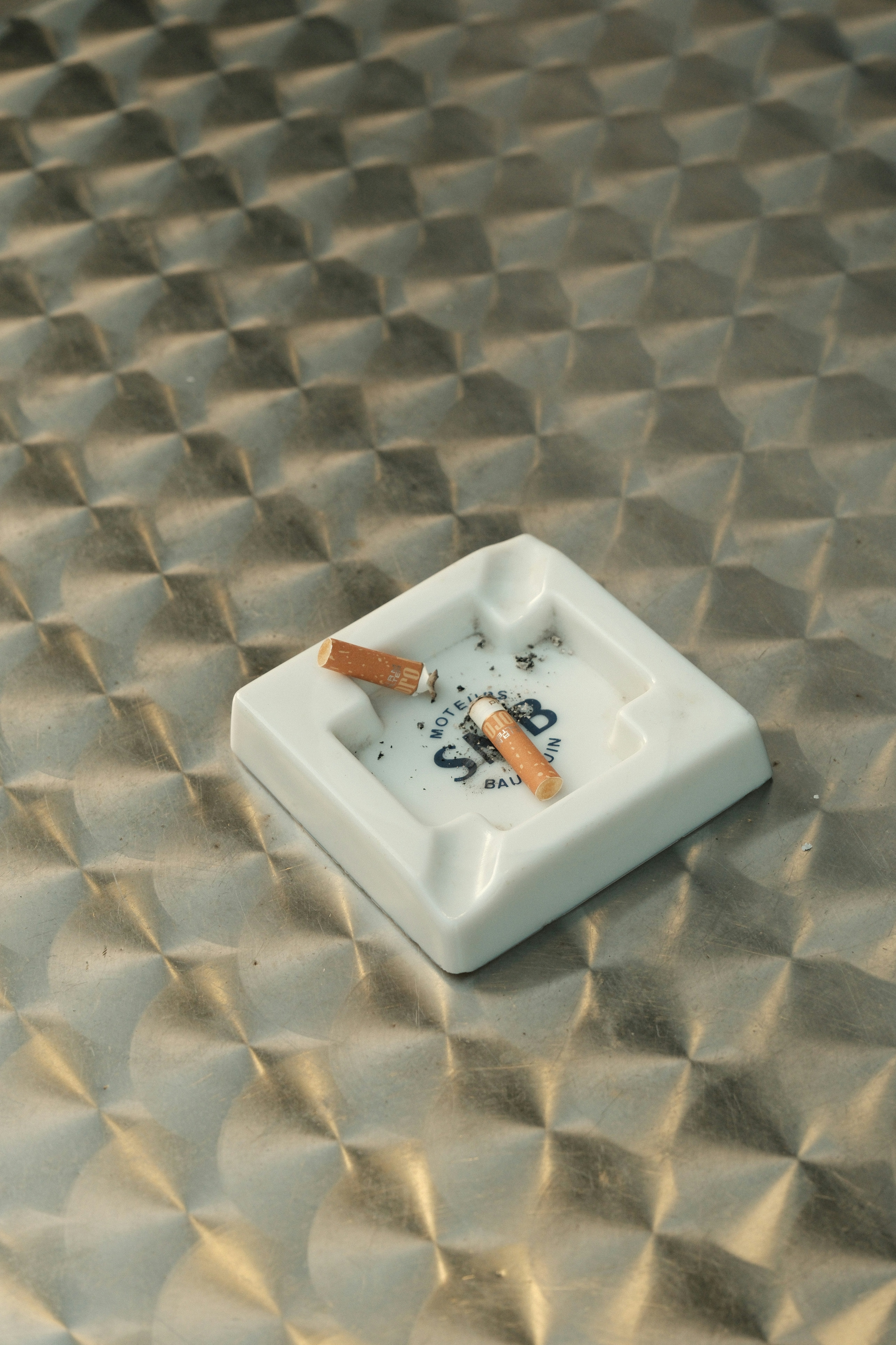 A cigarette holder sitting on top of a shiny surface