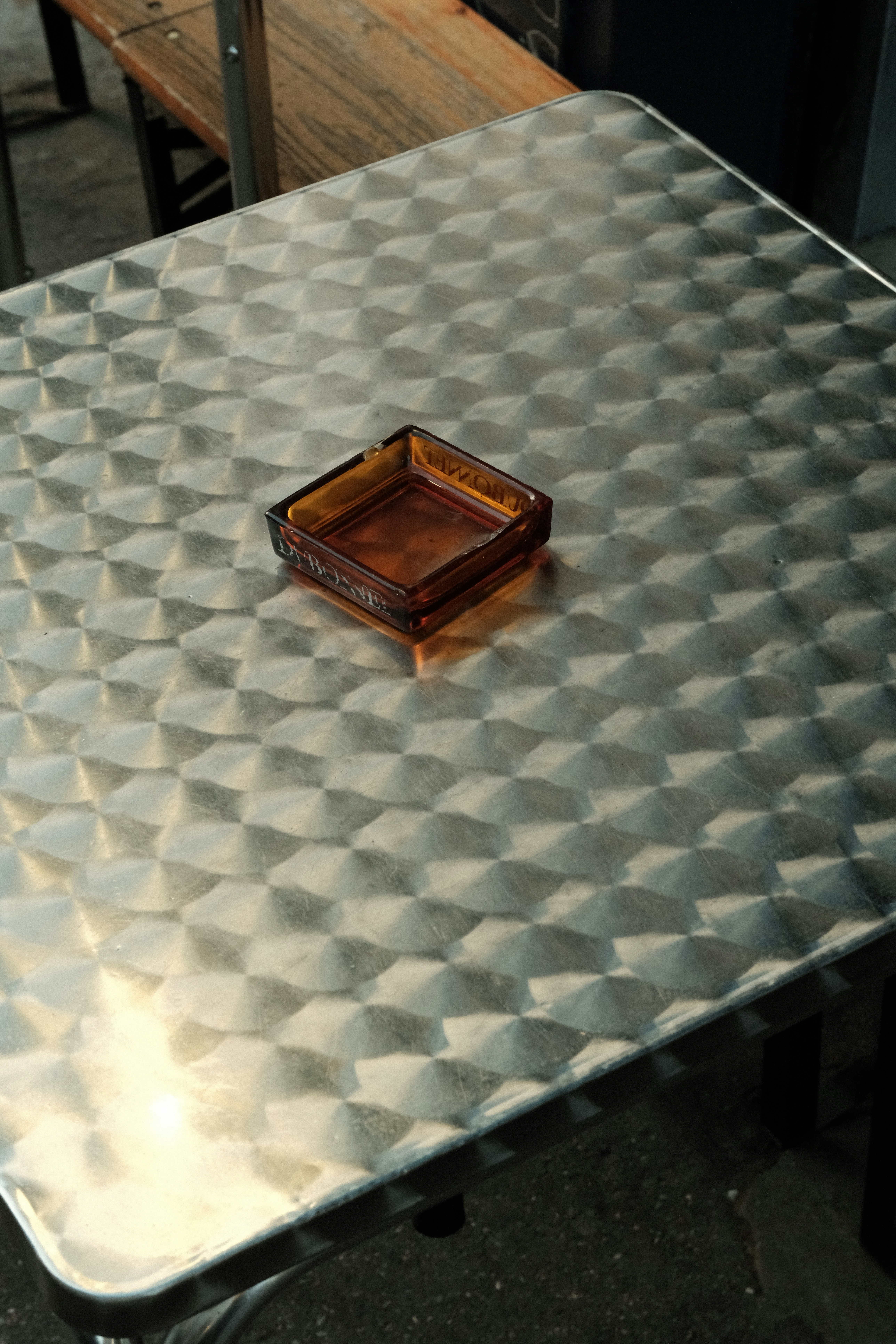 A metal table with a wooden tray on top of it