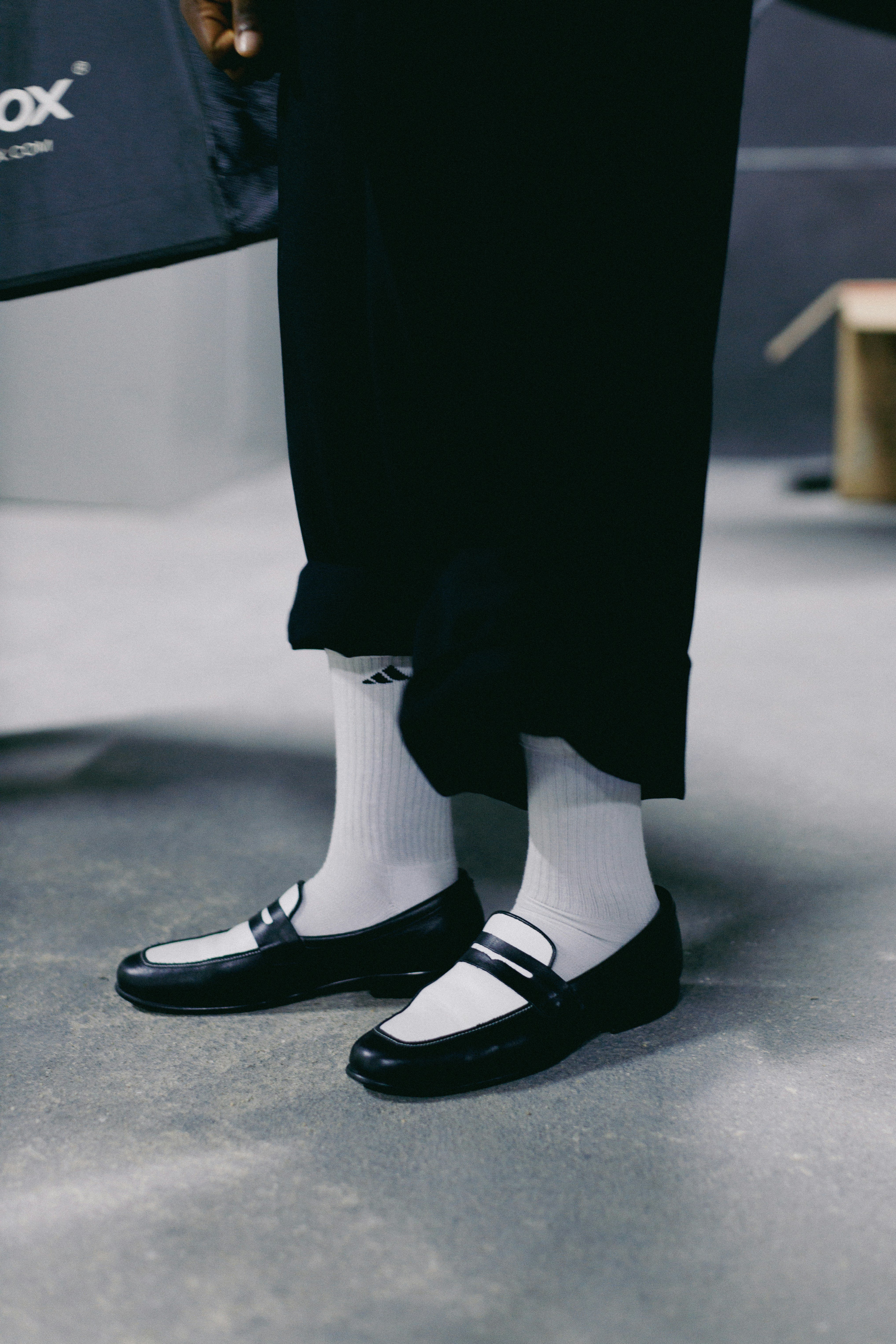A person with white socks and black shoes