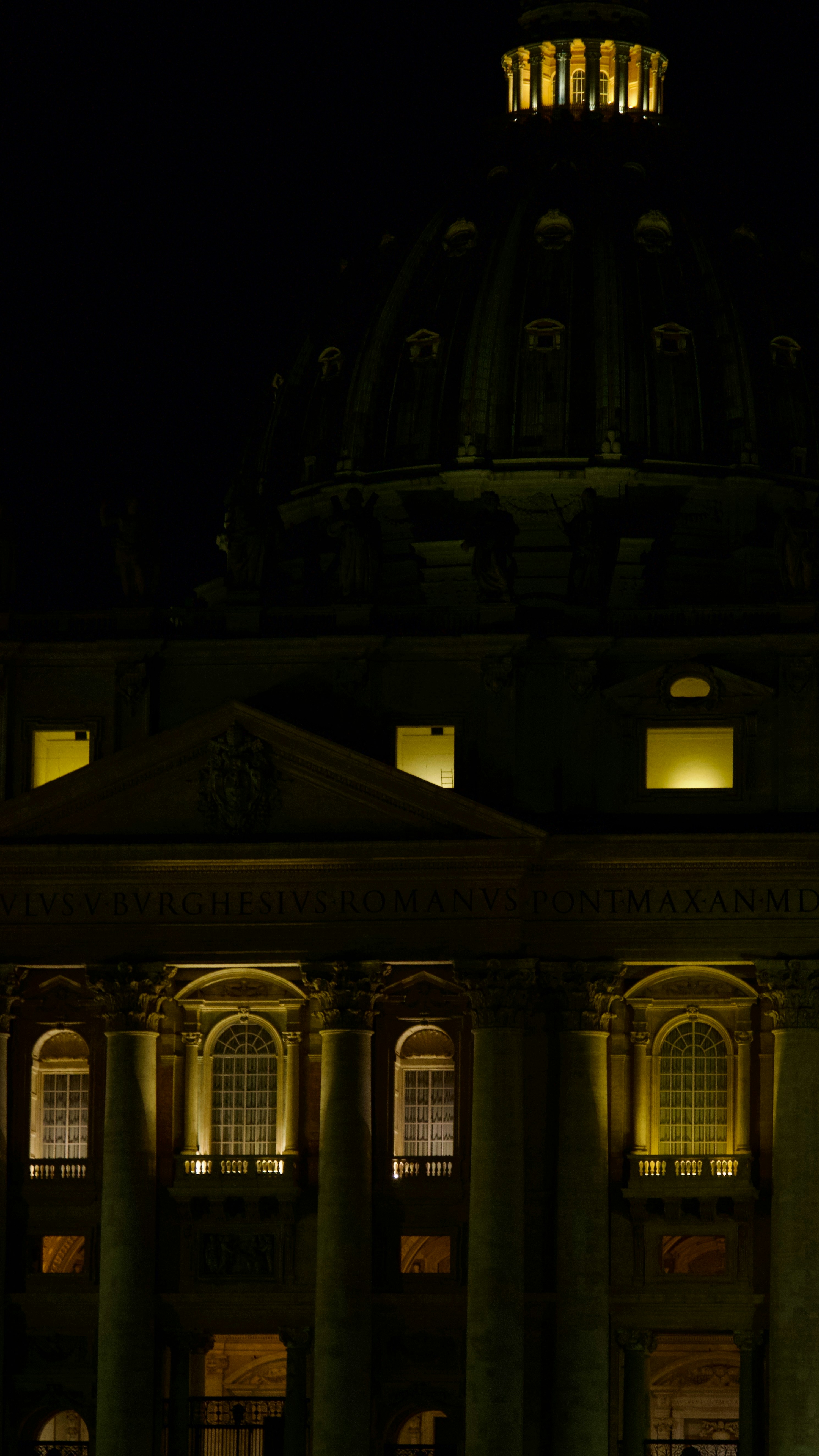A building lit up at night with a clock tower
