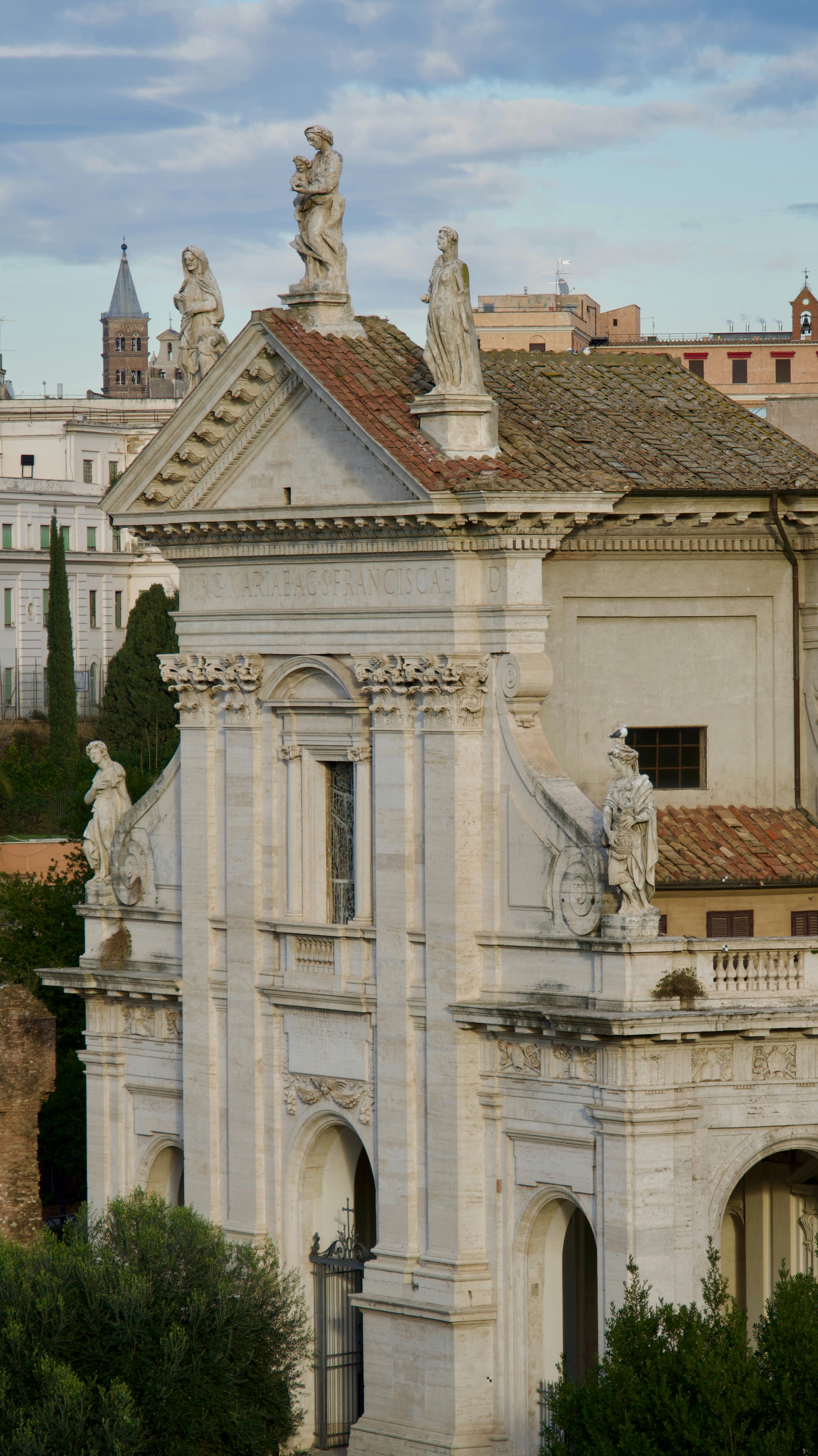 A large white building with statues on top of it