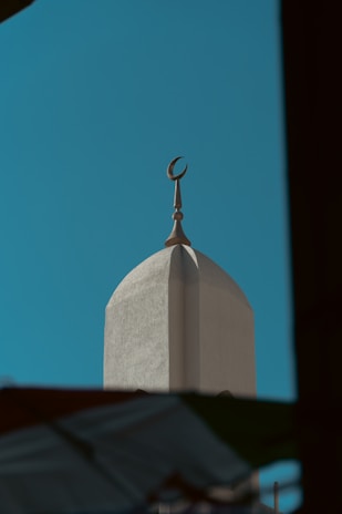 A tall white building with a crescent on top