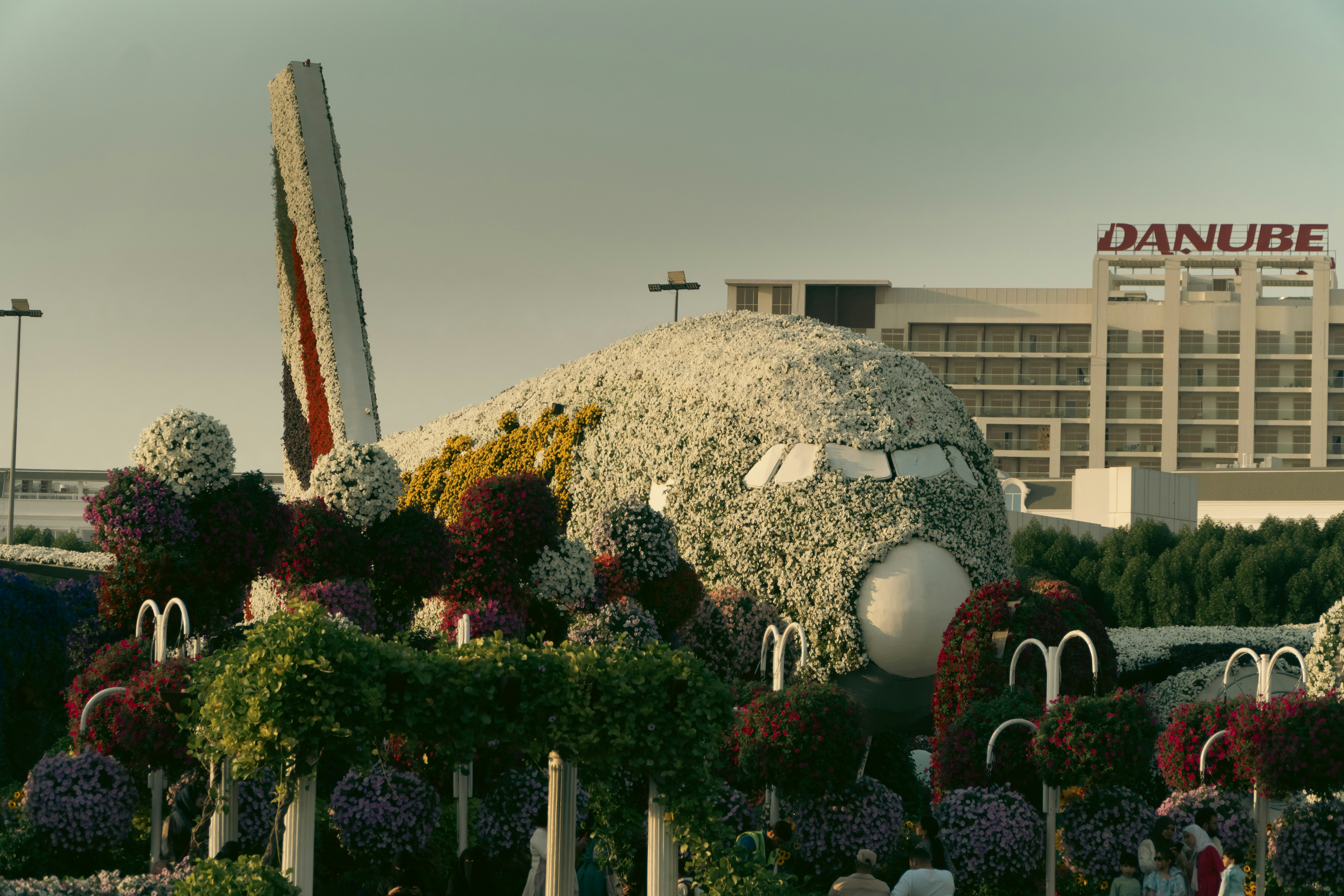 A large building with a lot of flowers in front of it