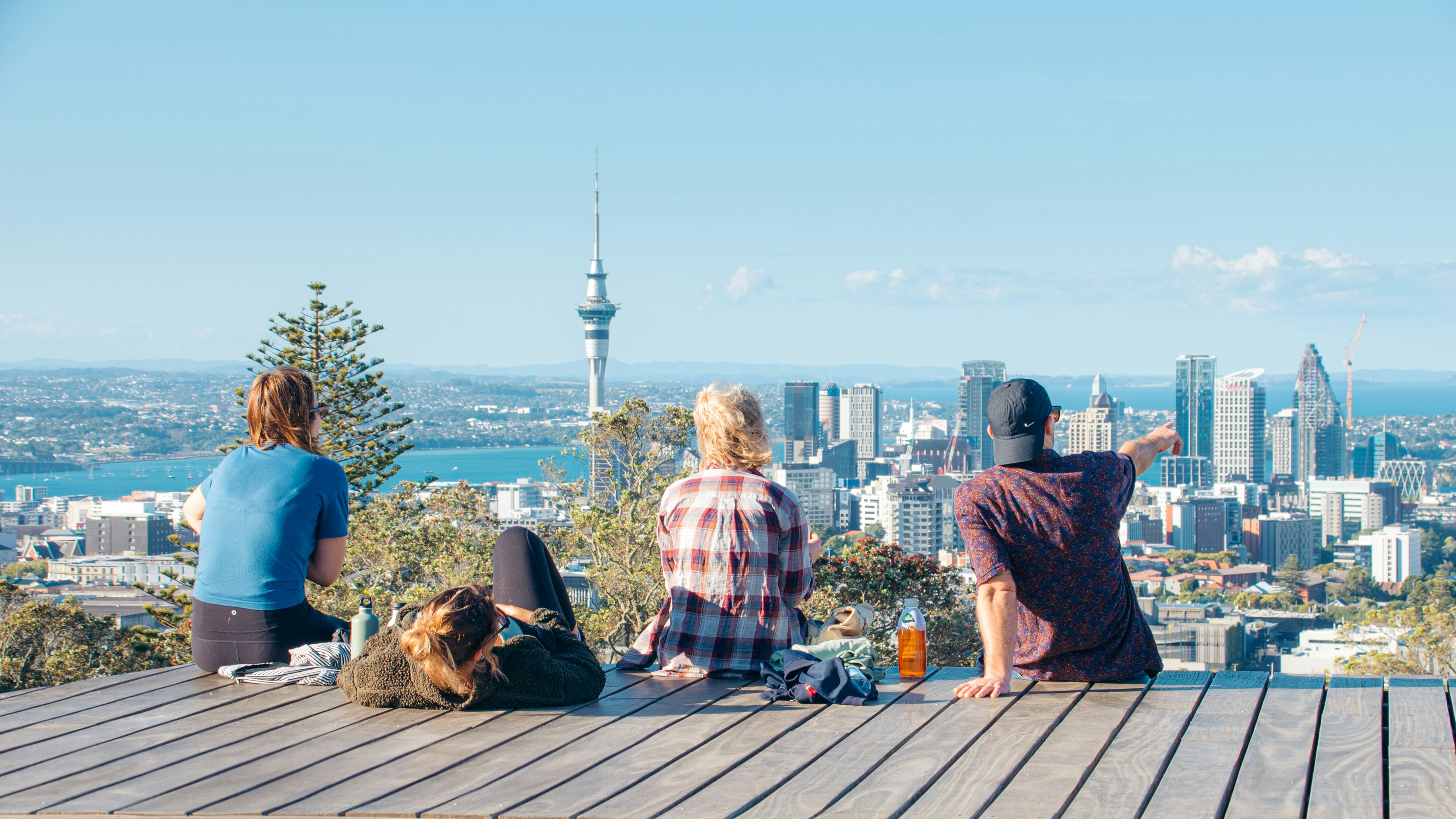 A group of people sitting on top of a wooden platform