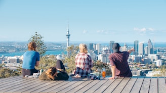 A group of people sitting on top of a wooden platform