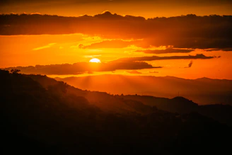 The sun is setting over a mountain range