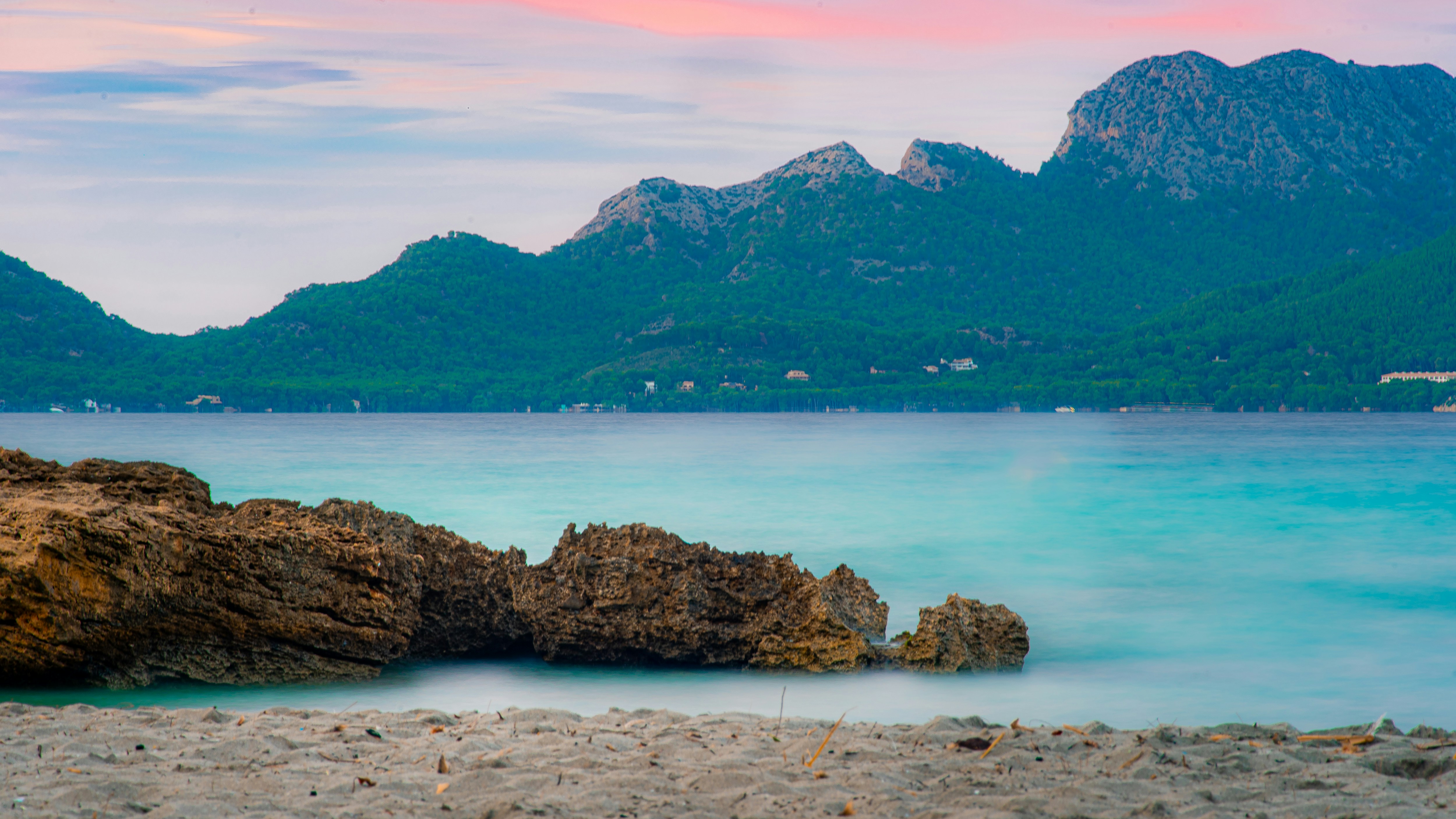 A body of water with mountains in the background