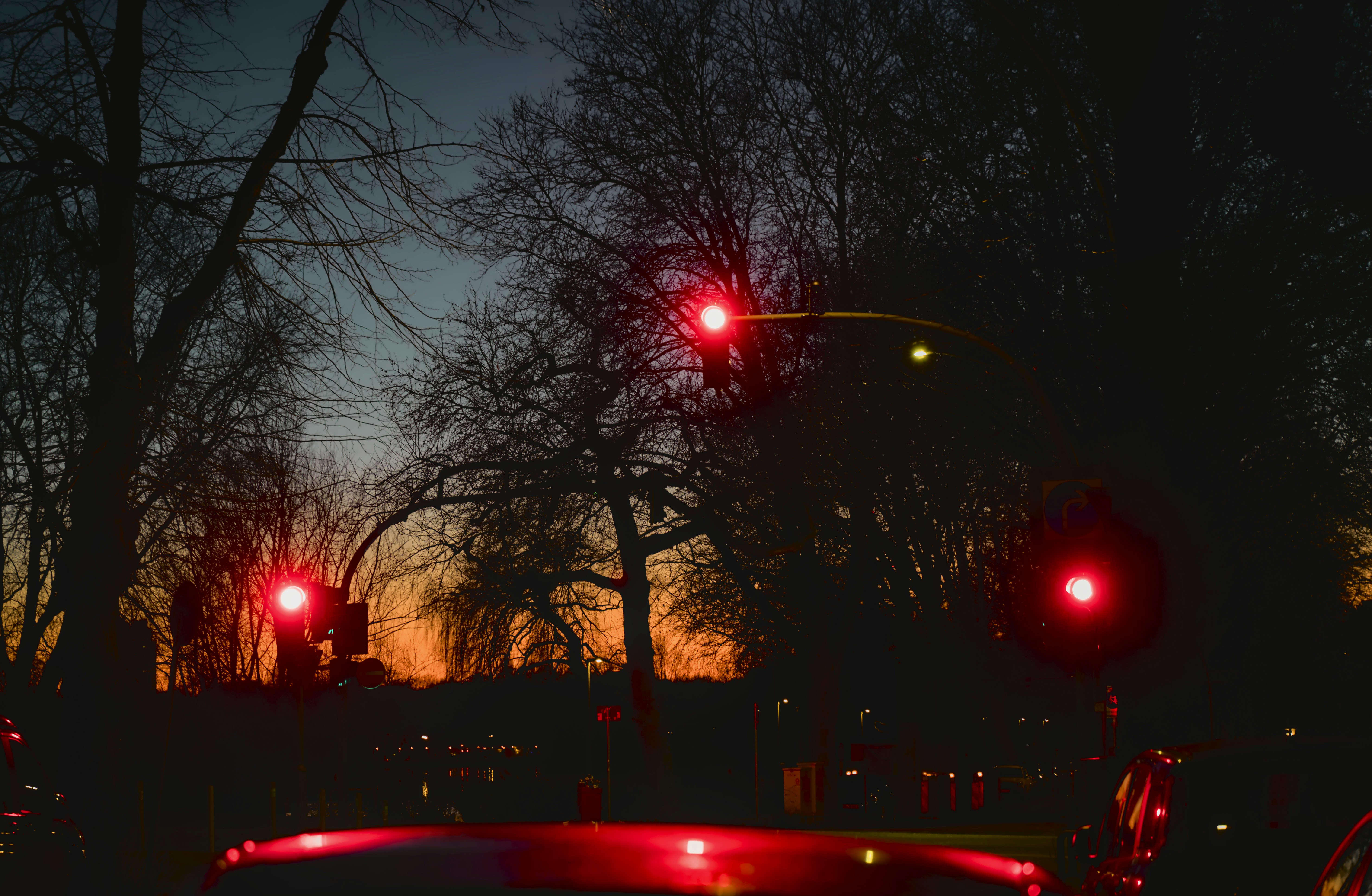 A car stopped at a red light at night