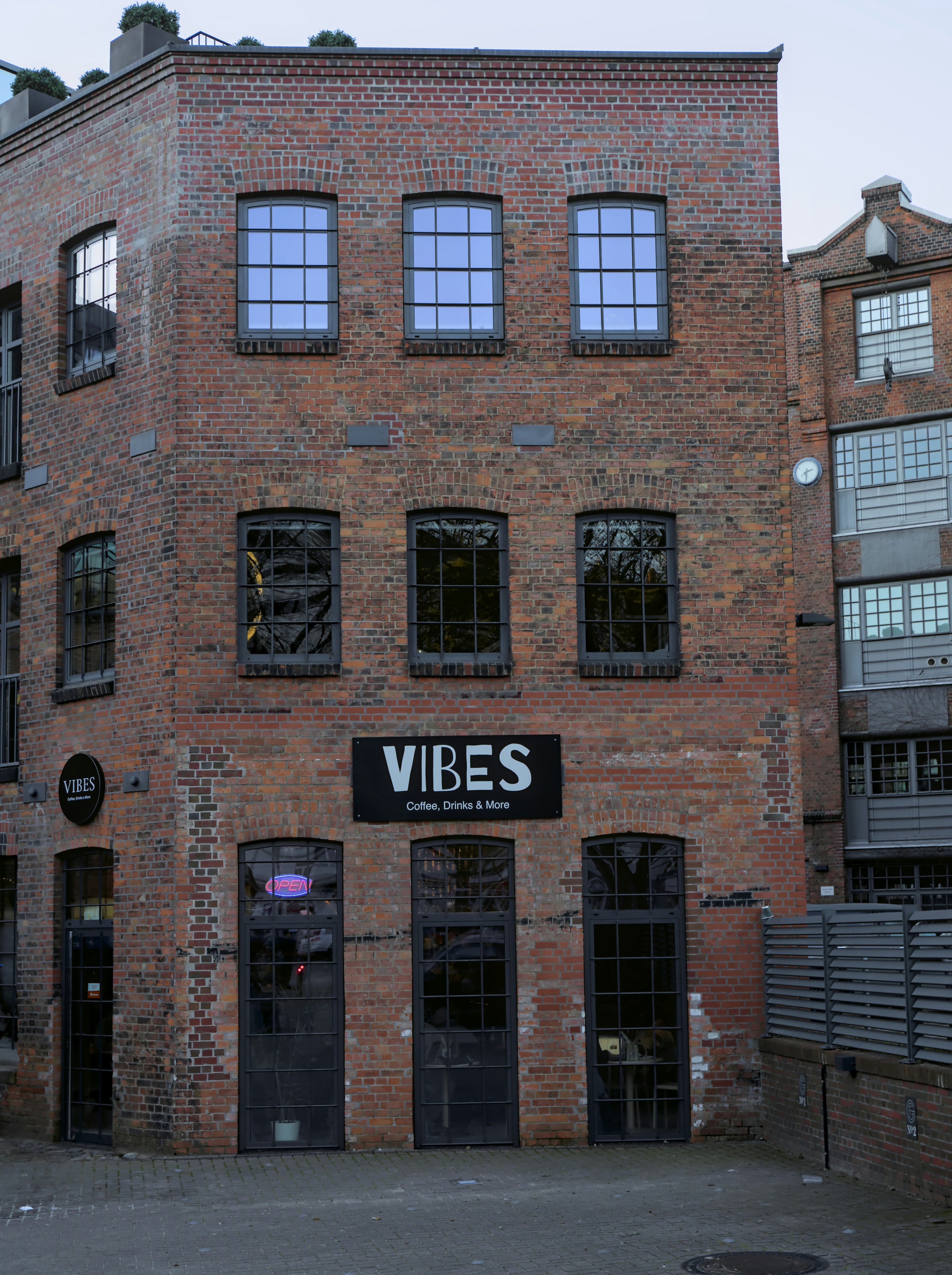 A brick building with a sign that reads vibes