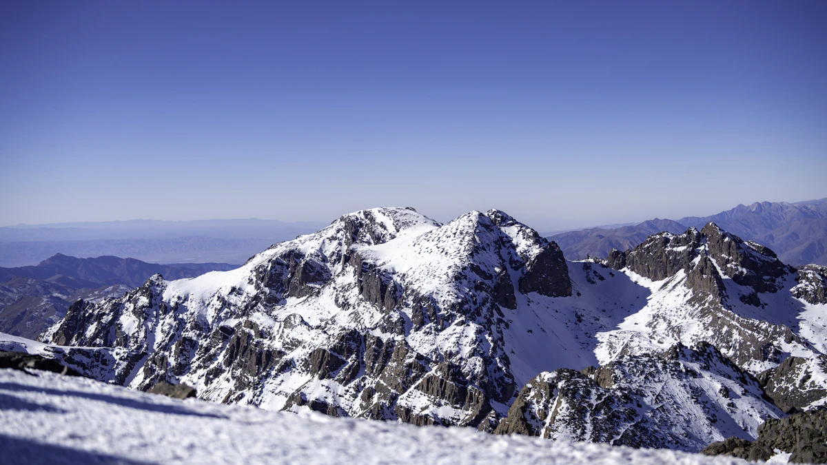 Snow-covered High Atlas summit under a blue sky, Morocco
