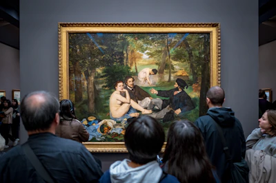 A group of people standing in front of a painting