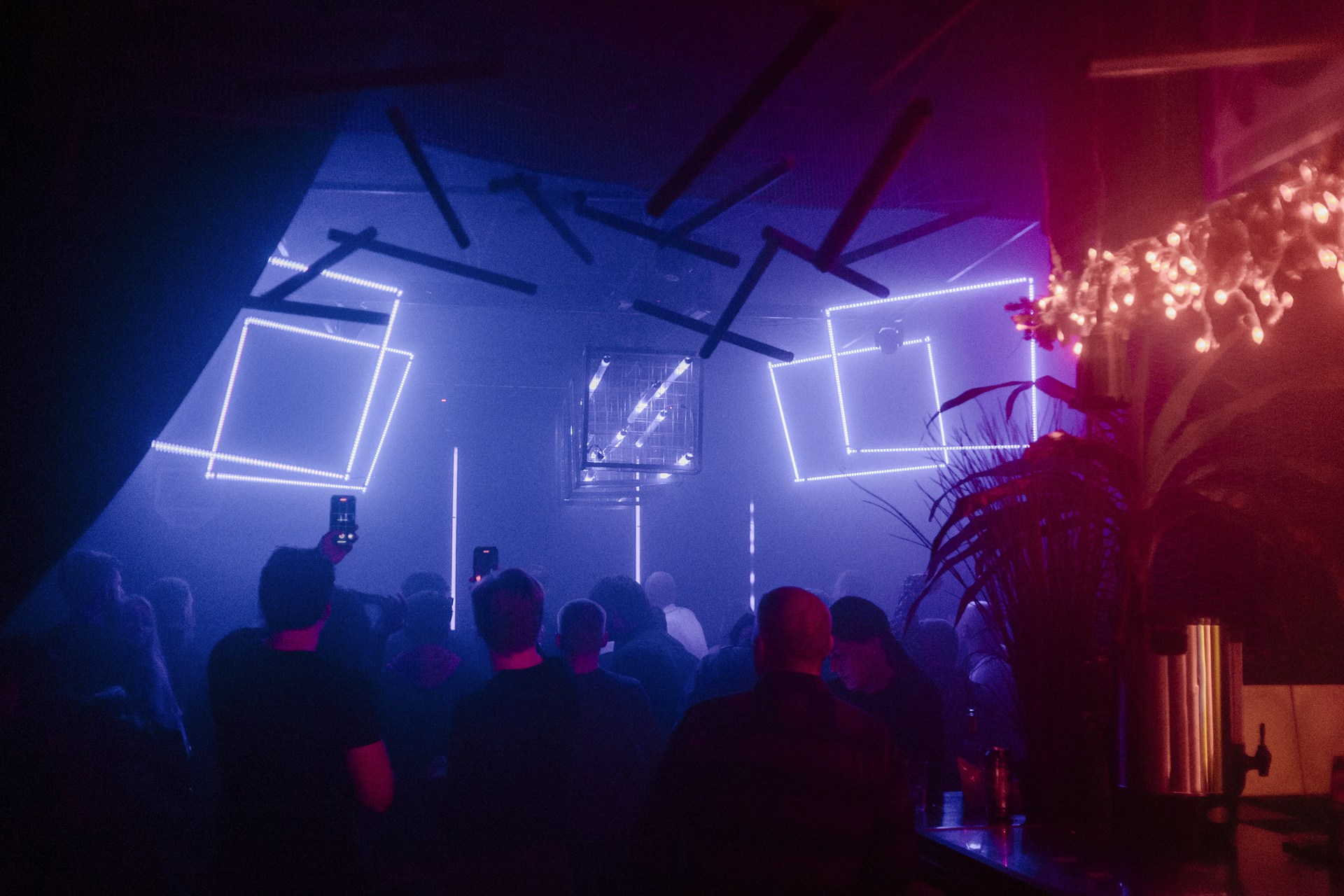 A group of people standing in a room with lights on