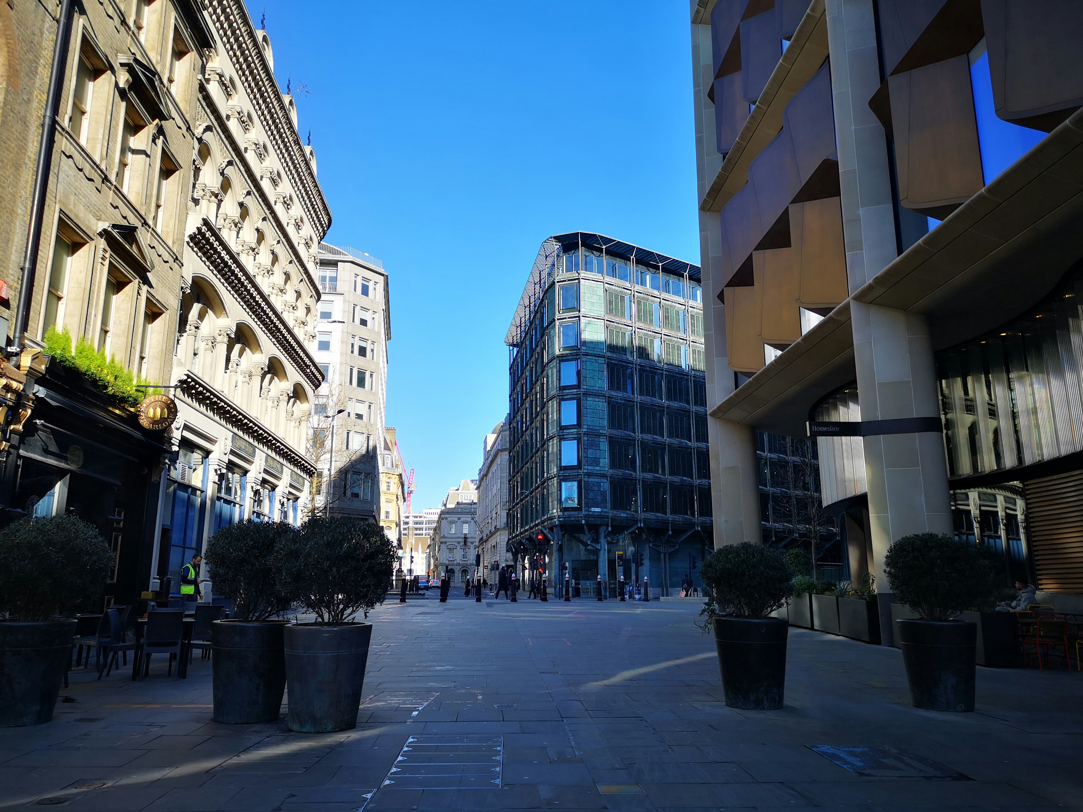 A city street lined with tall buildings next to tall buildings