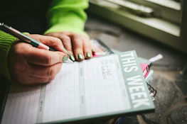 A person writing on a piece of paper