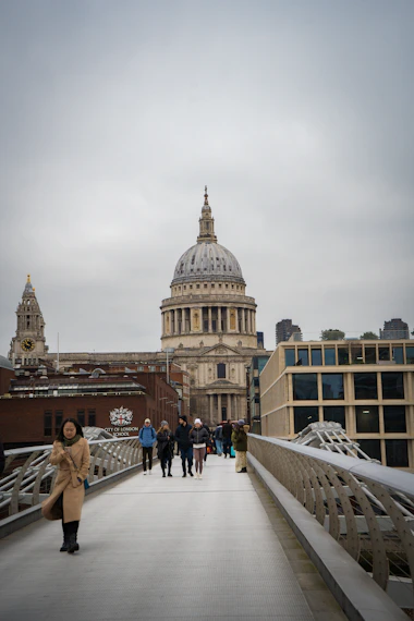 A group of people walking across a bridge