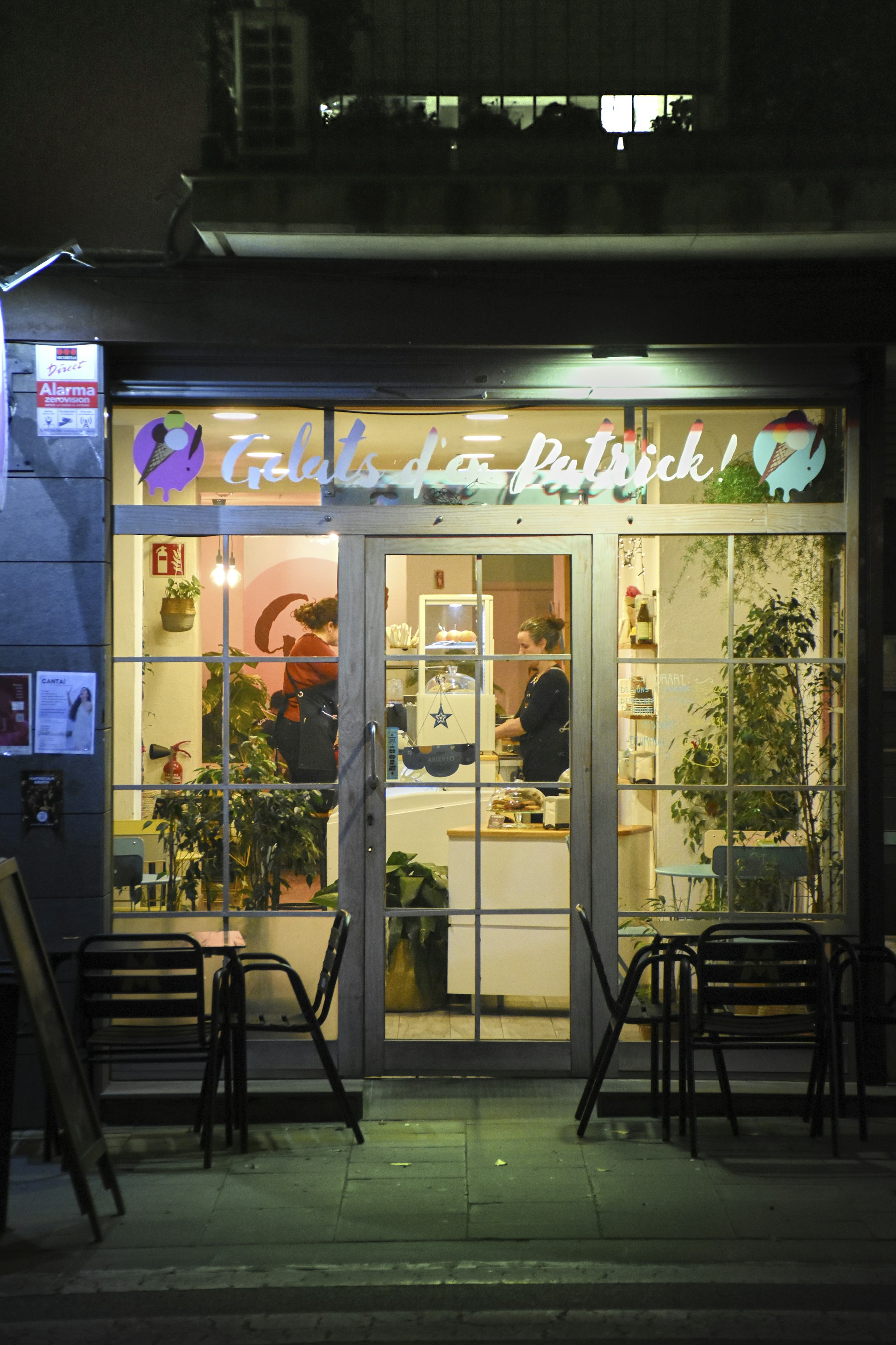 A store front at night with lights on