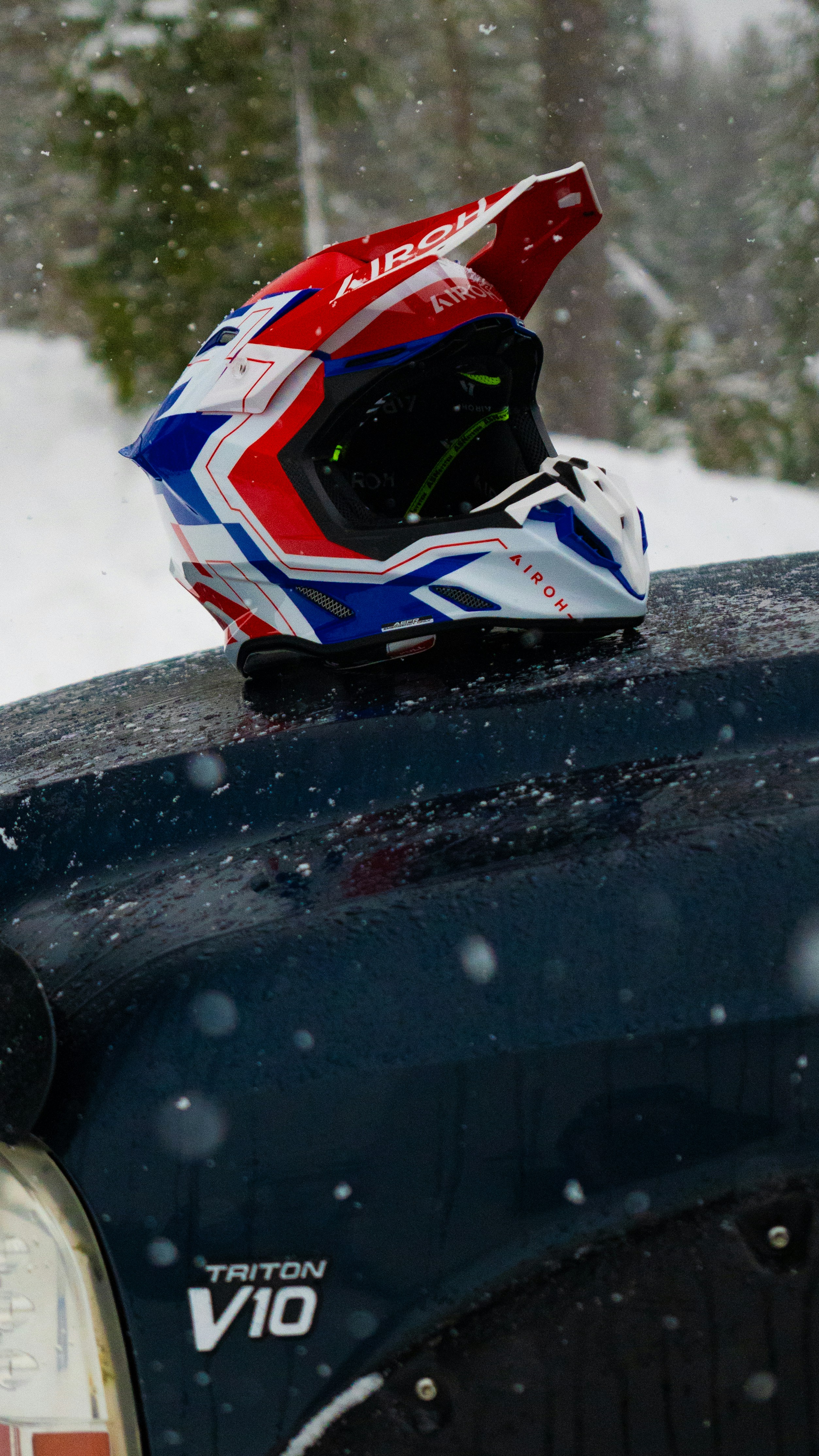 A helmet on the back of a truck in the snow