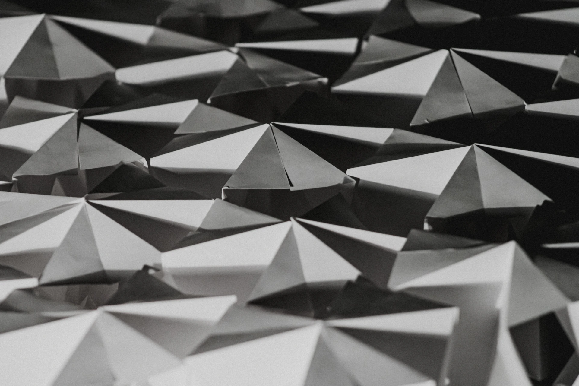 A black and white photo of a surface with many triangular shapes